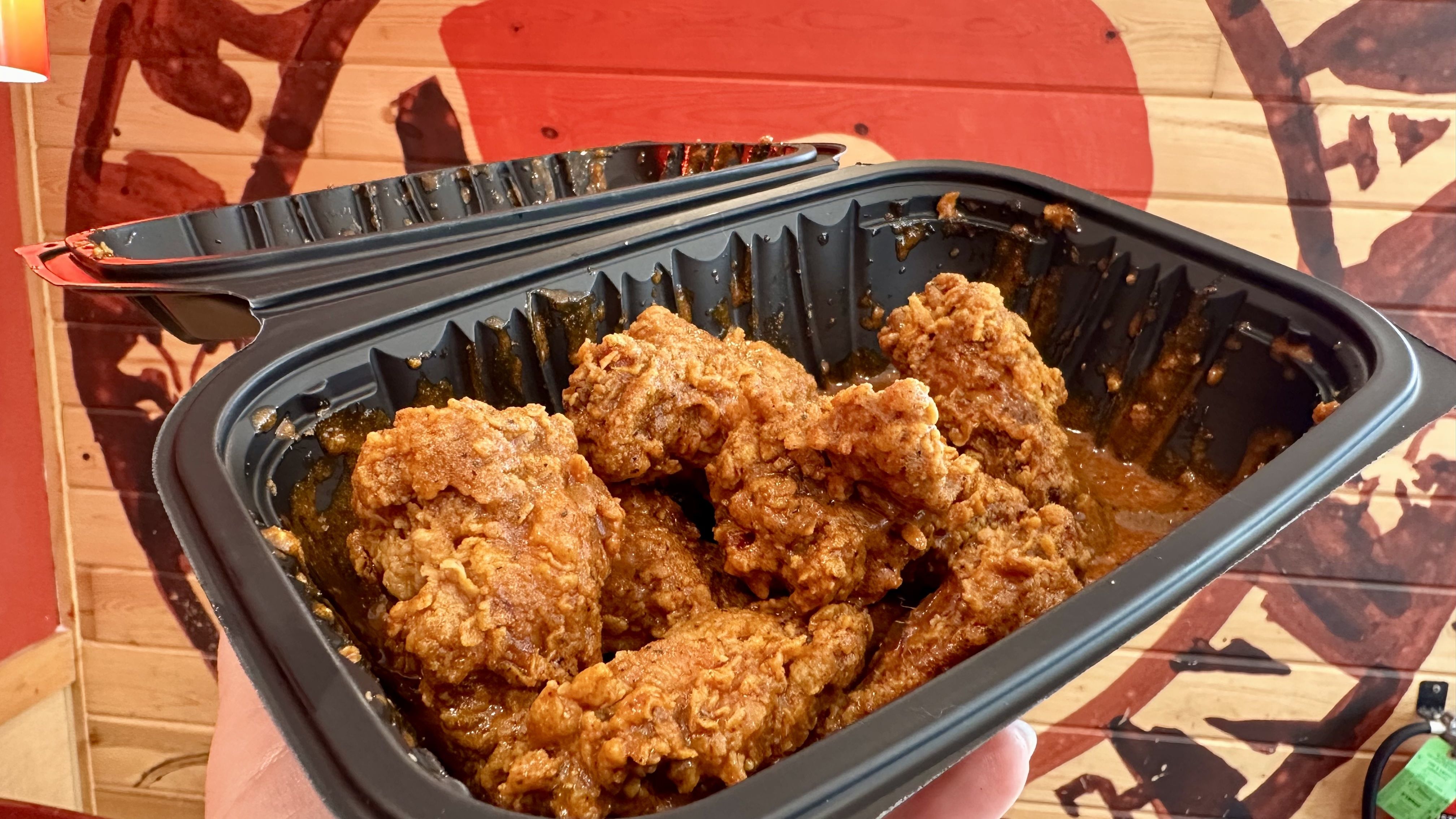 photo shows wings in a black container