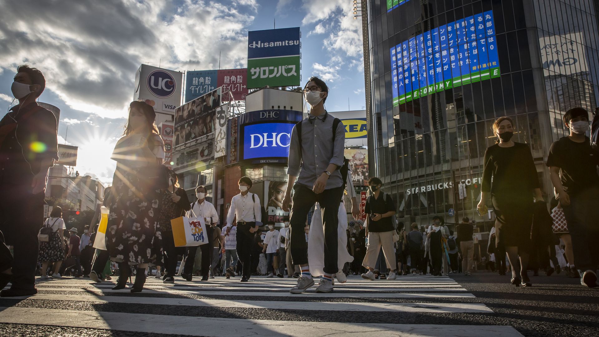 People wearing face masks cross Shibuya crossing on July 27, 2021 in Tokyo, Japan.