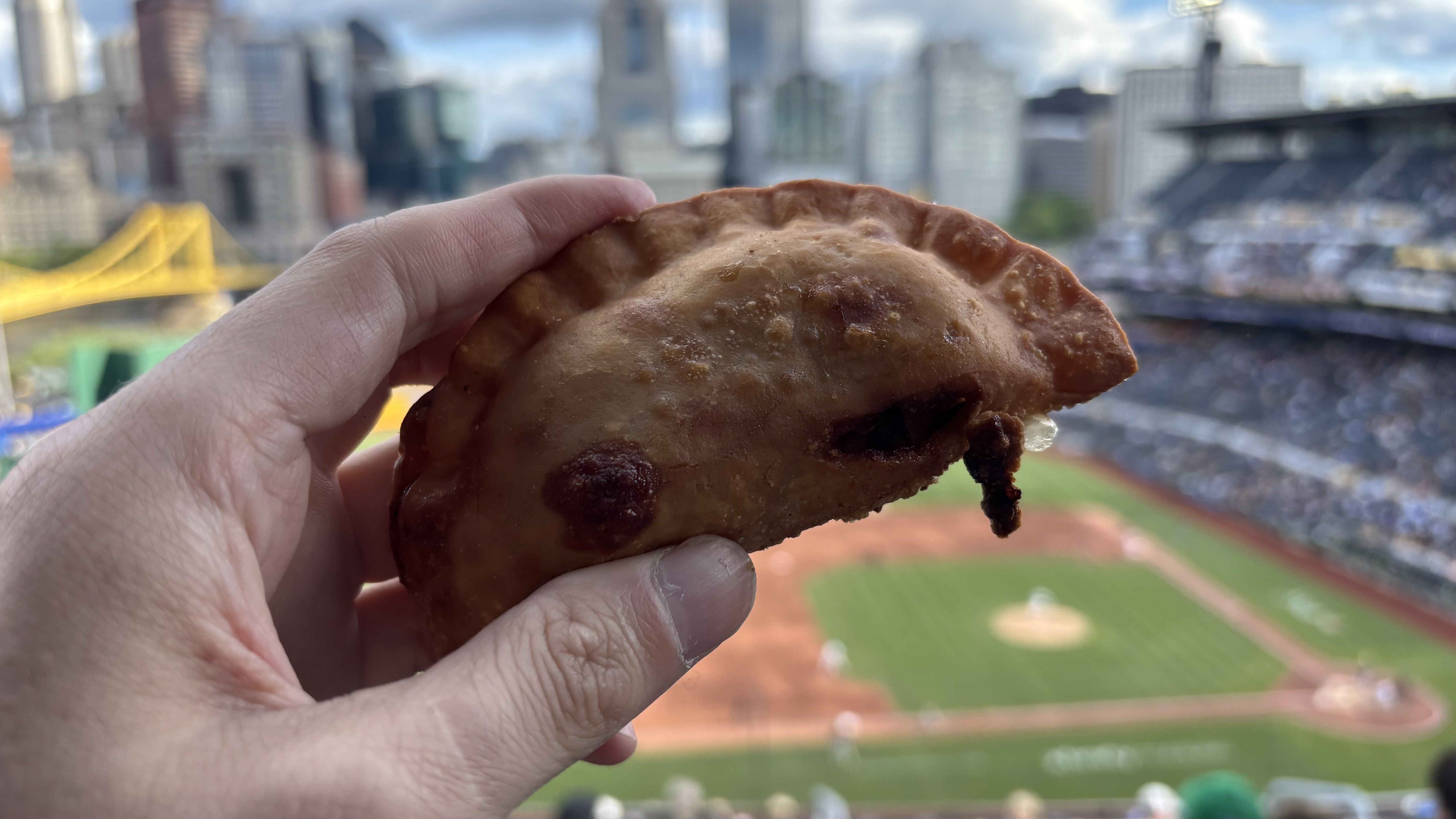 Chipped ham empanadas are fried pastries filled with chipped chopped ham, cheddar cheese and pickles, and served with a sweet, ketchupy barbecue sauce at the Pittsburgh Pirates game