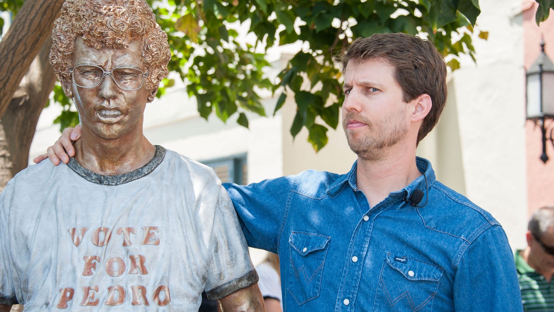 Actor Jon Heder stands next to a statue of his likeness in the movie "Napoleon Dynamite."
