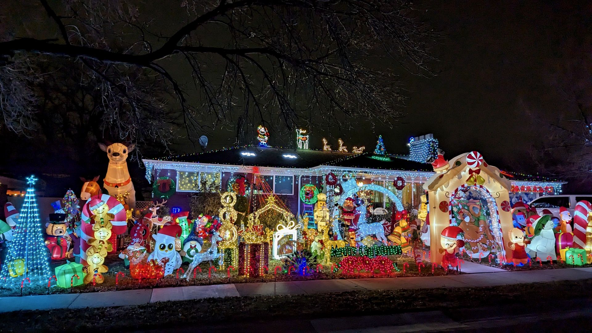 A house with lots of lighted Christmas decorations.