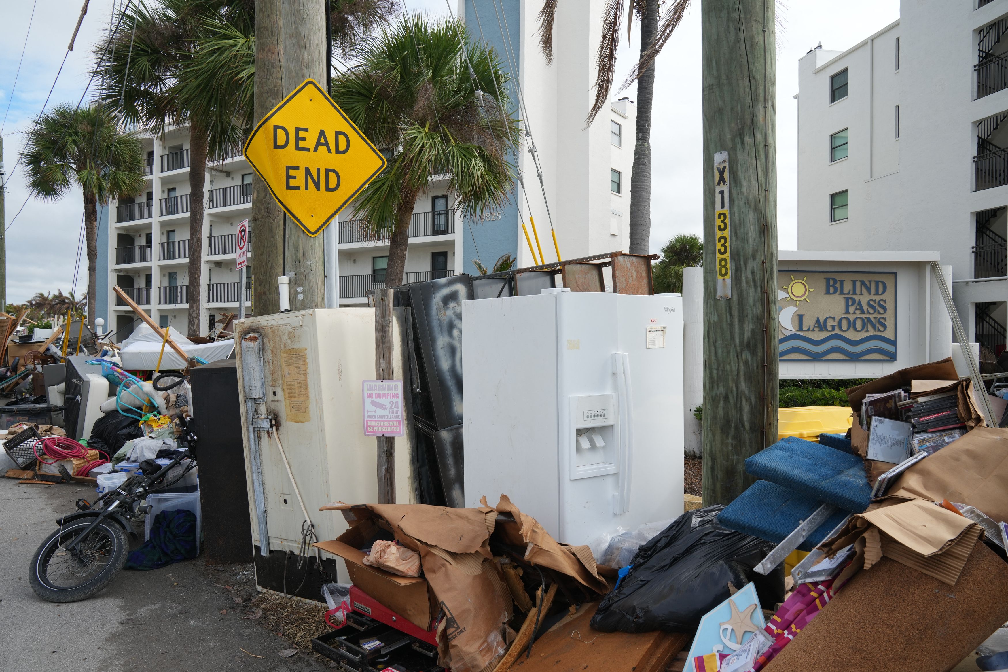 Debris left by Hurricane Helene is piled up in the street ahead of Hurricane Milton's expected landfall in the middle of this week in Treasure Island, Florida on October 7, 2024. Florida's governor has declared a state of emergency on Saturday as forecasters warned that Hurricane Milton is expected 