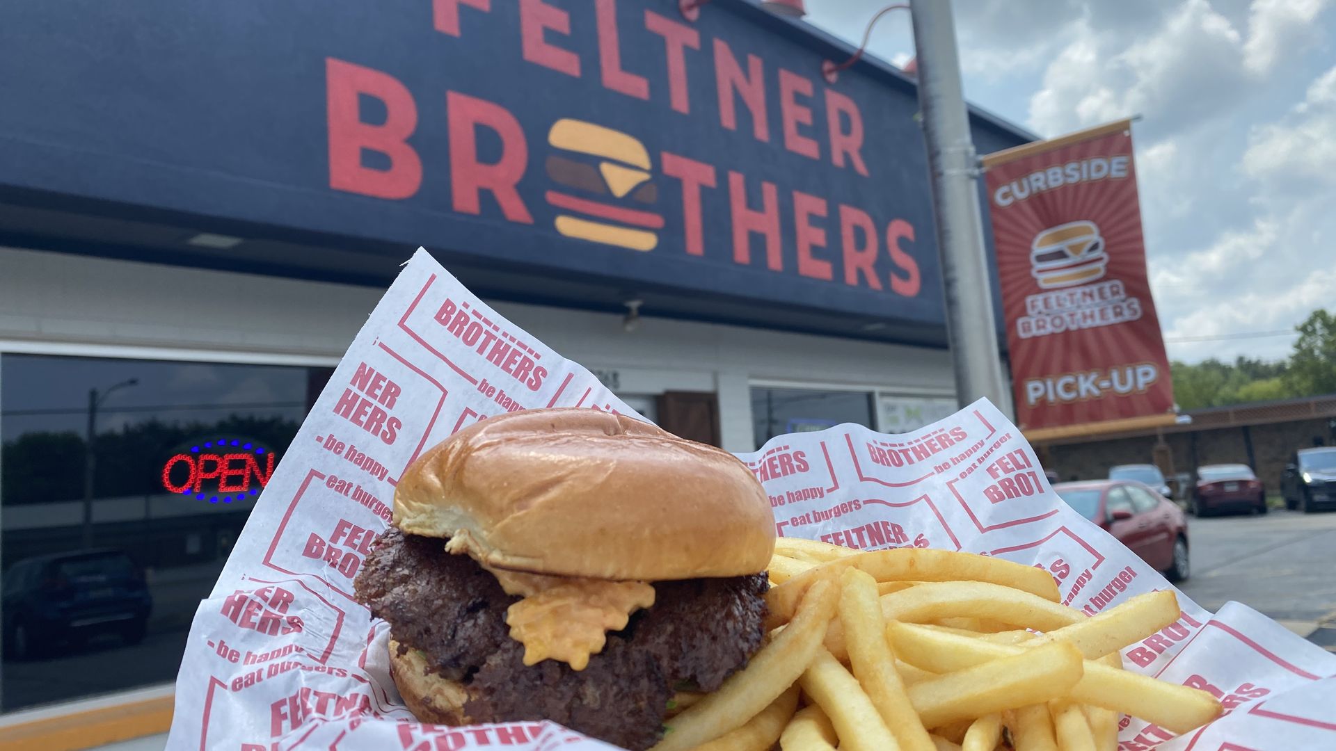 A photo of burger and fries in front of Feltner Brothers in Fayetteville, Ark. 