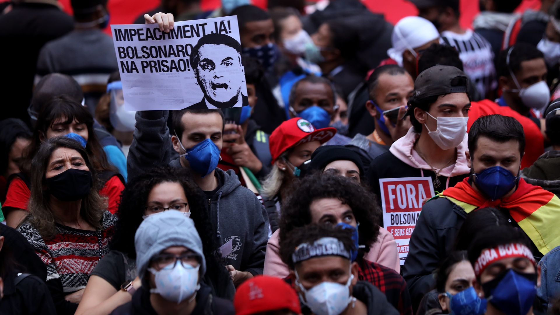 Demonstrators gather holding signs during a protest against Bolsonaro's administration on June 19, 2021 in Sao Paulo, Brazil.