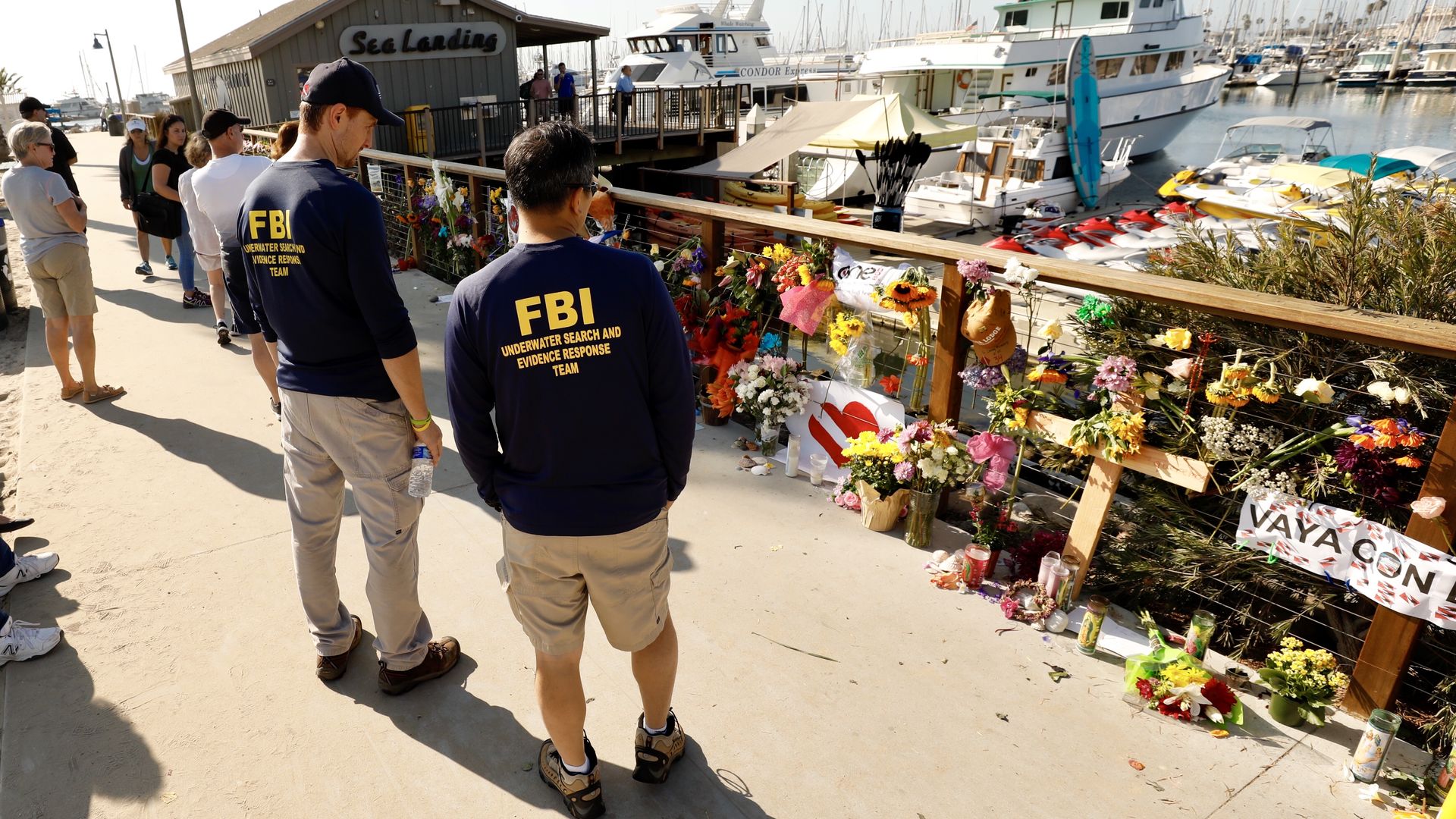 Members of the FBI dive team view a growing memorial in Santa Barbara Harbor for 34 victims of the Conception boat tragedy September 5, 2019 in Santa Barbara, California.