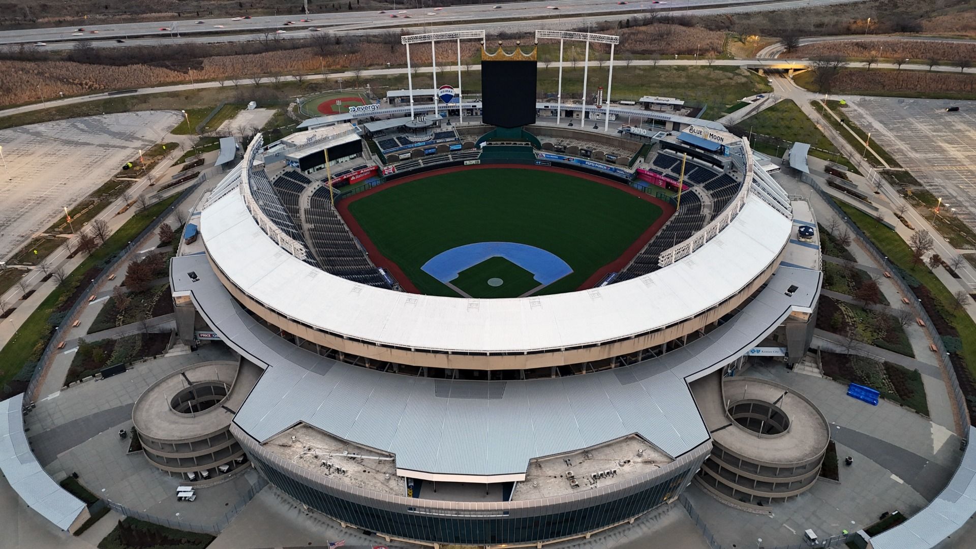Aerial photo of Kauffman Stadium looking north toward the highway with all the lights off during the day.