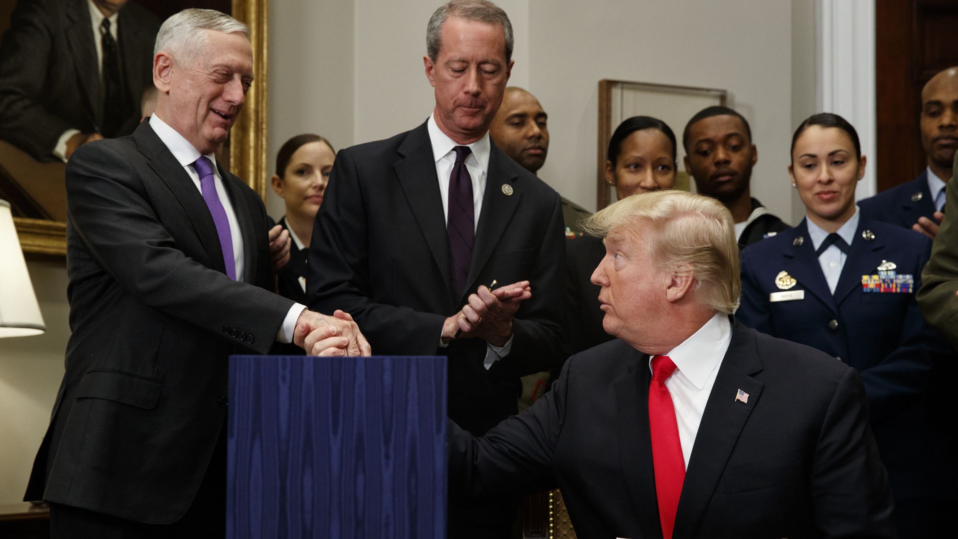 President Donald Trump shakes hands with Secretary of Defense Jim Mattis after signing the National Defense Authorization Act for Fiscal Year 2018.