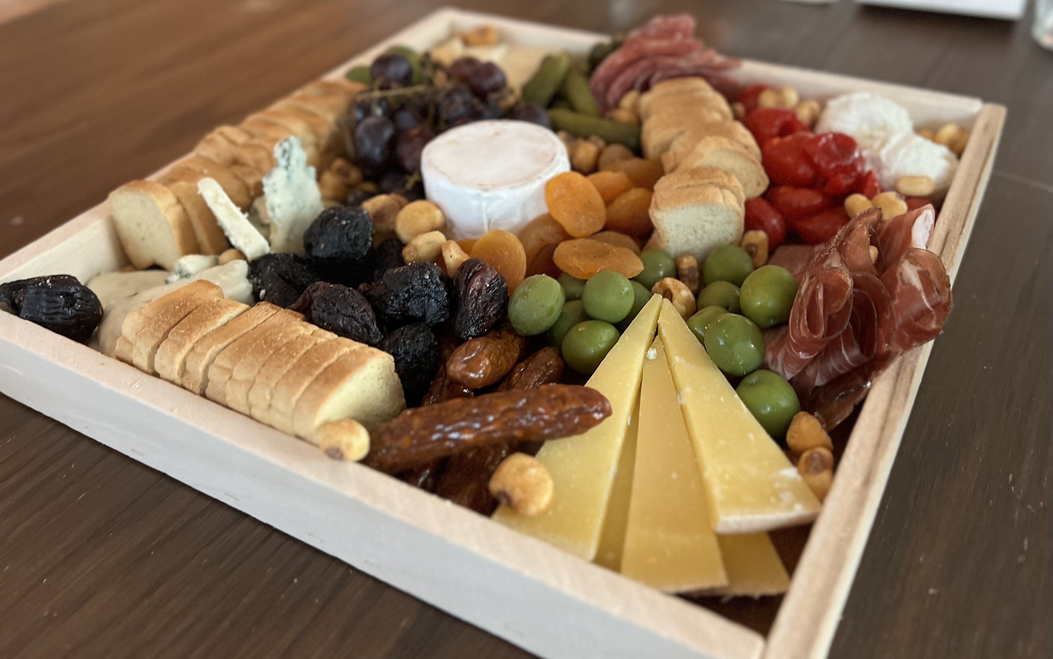 A photo of a cheese board on a table.
