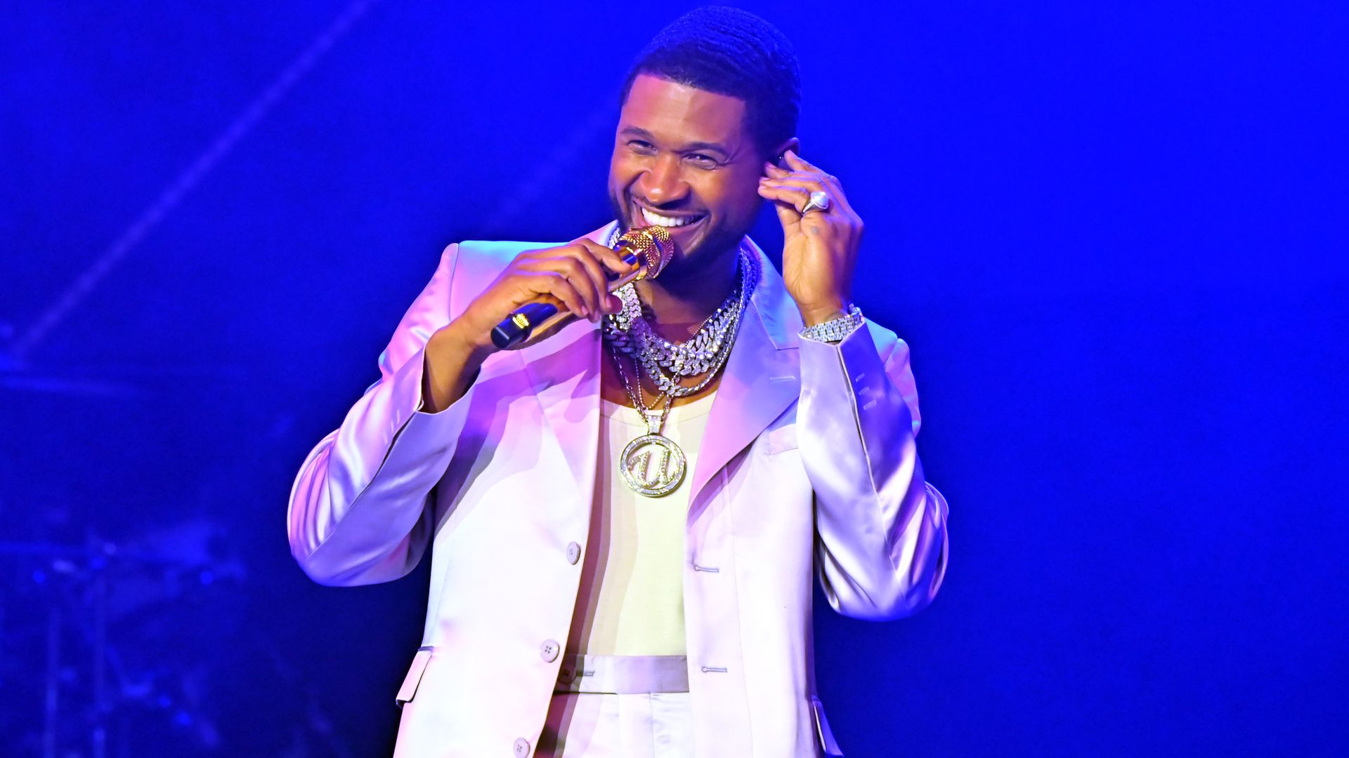 Usher holding a microphone