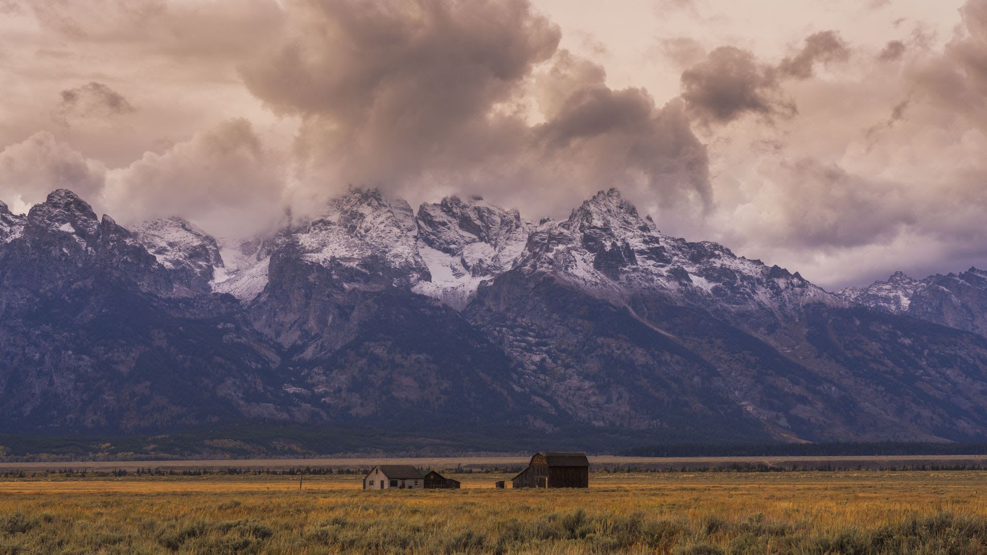 A cabin in front of a mountain range in Grand Teton National Park, Wyoming.