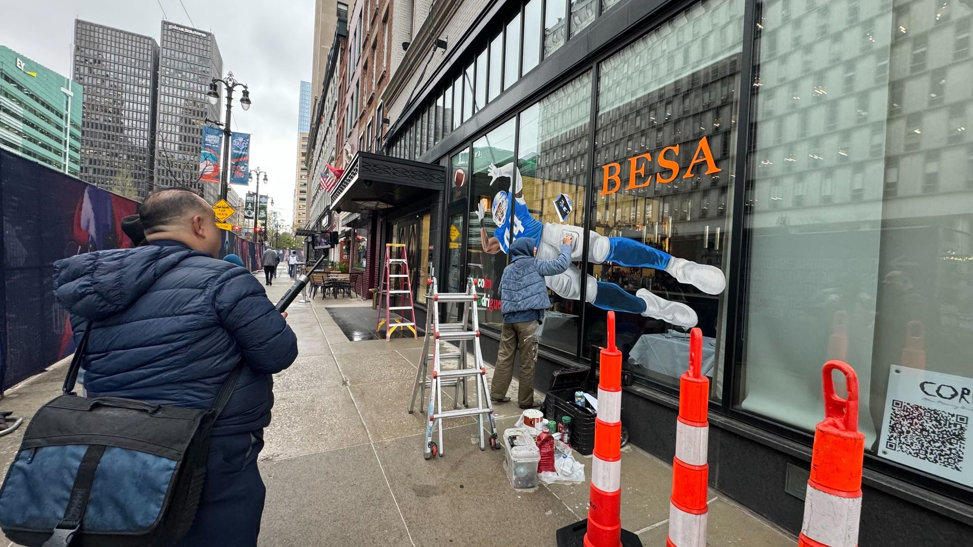 An image of a Detroit Lions player is painted on a window facing Woodward Avenue at Besa restaurant.