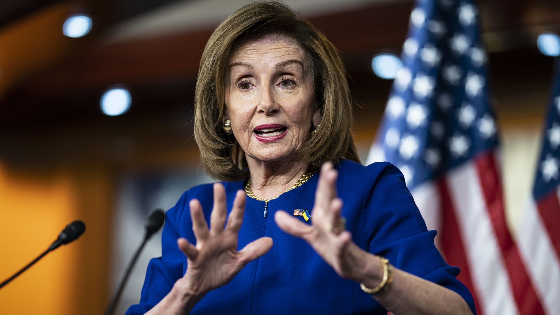 House Speaker Nancy Pelosi is seen gesturing with her hands during a news conference.