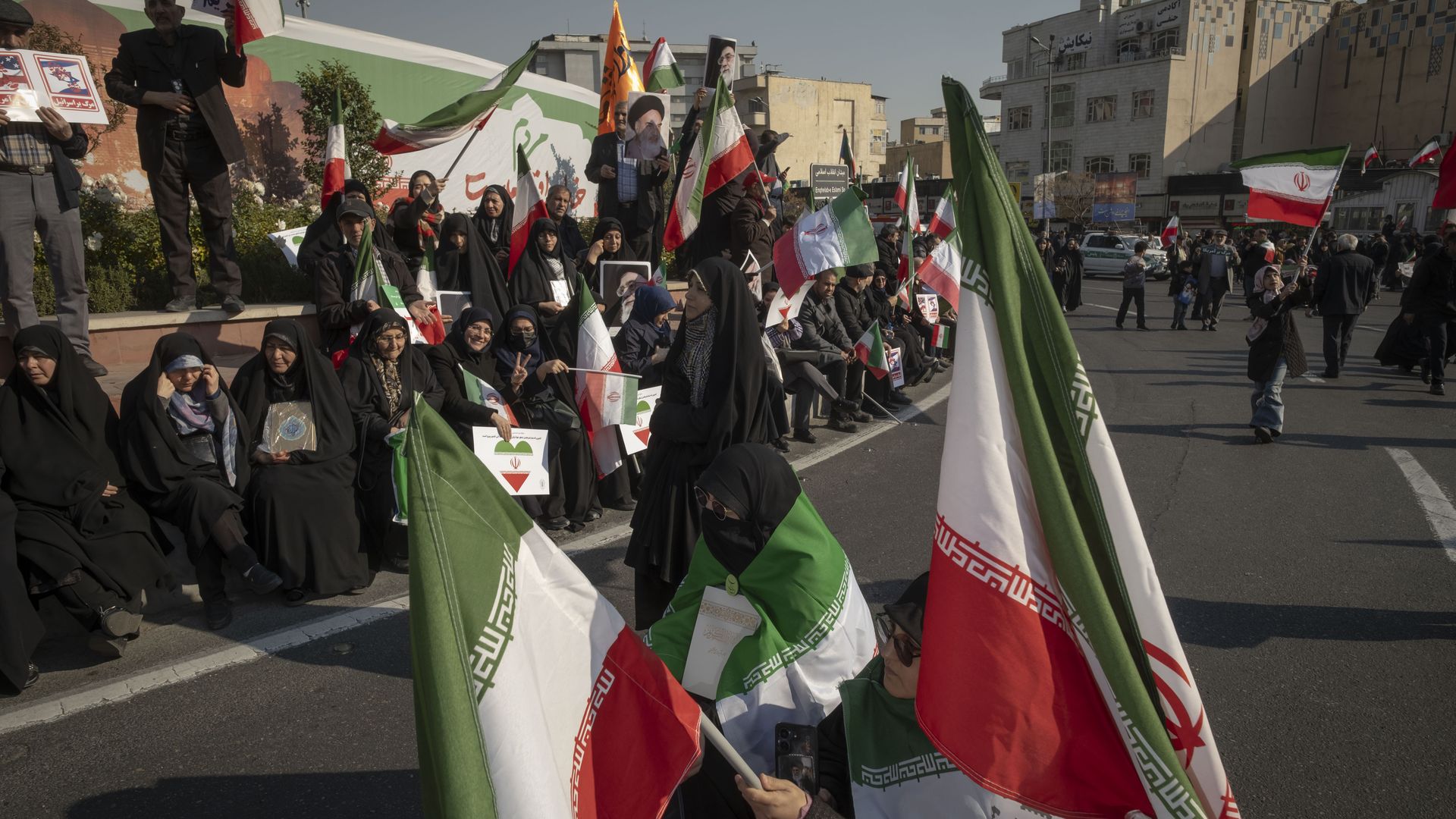 Iranian protesters carry country flags and participate in a pro-Government rally in Tehran, Iran, on January 12, 2026. The rally takes place in Tehran against the recent anti-government unrest, opposition to the U.S. and Israel in Iran, and in support of Supreme Leader Ayatollah Ali Khamenei. 