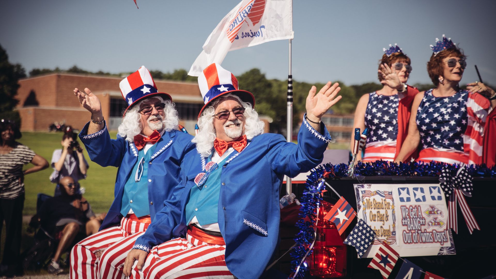 Two twins in Uncle Sam outfits ride in a parade in Twinsburg, Ohio.