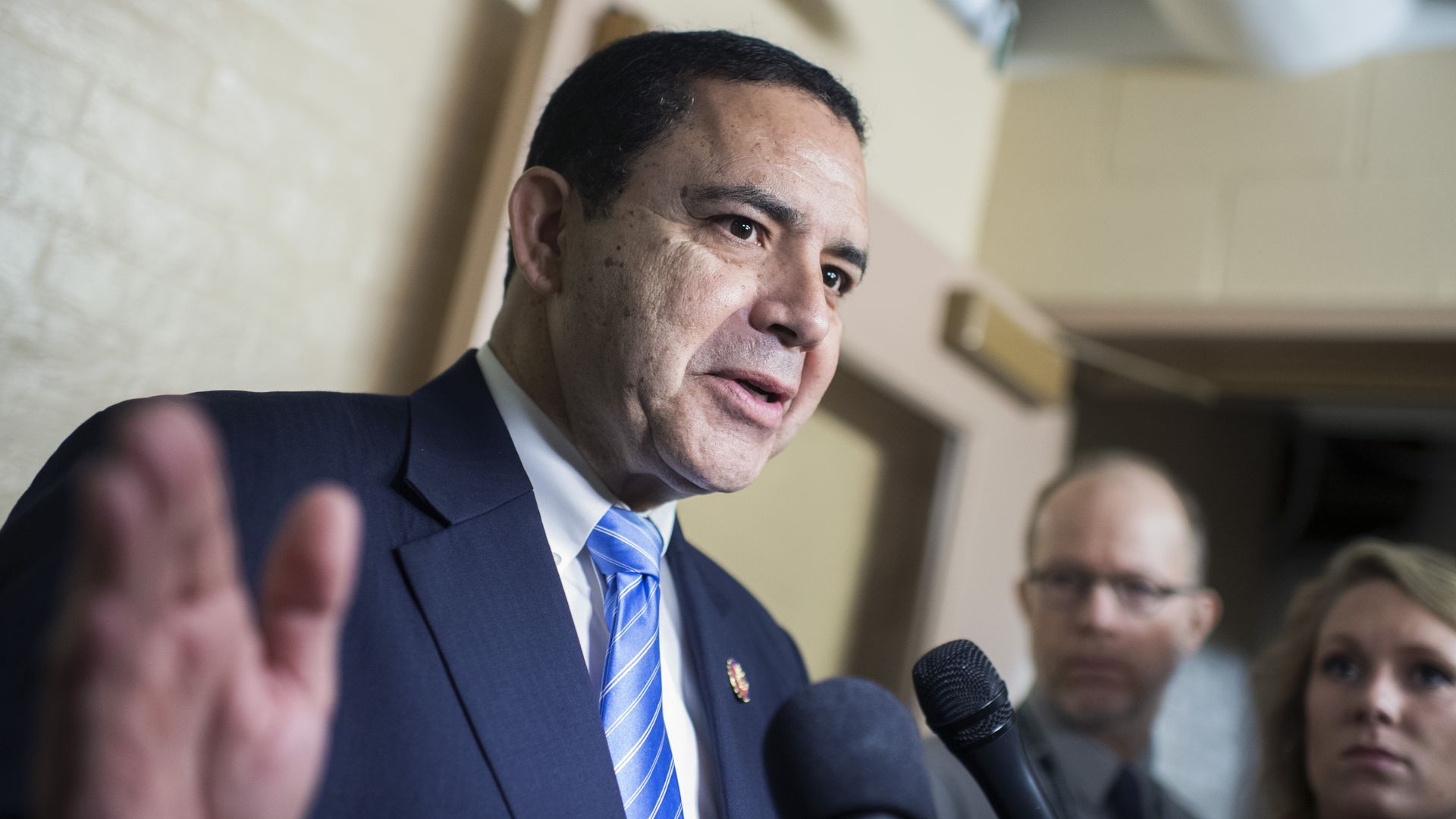 Rep. Henry Cuellar talks with reporters in the Capitol after a meeting 