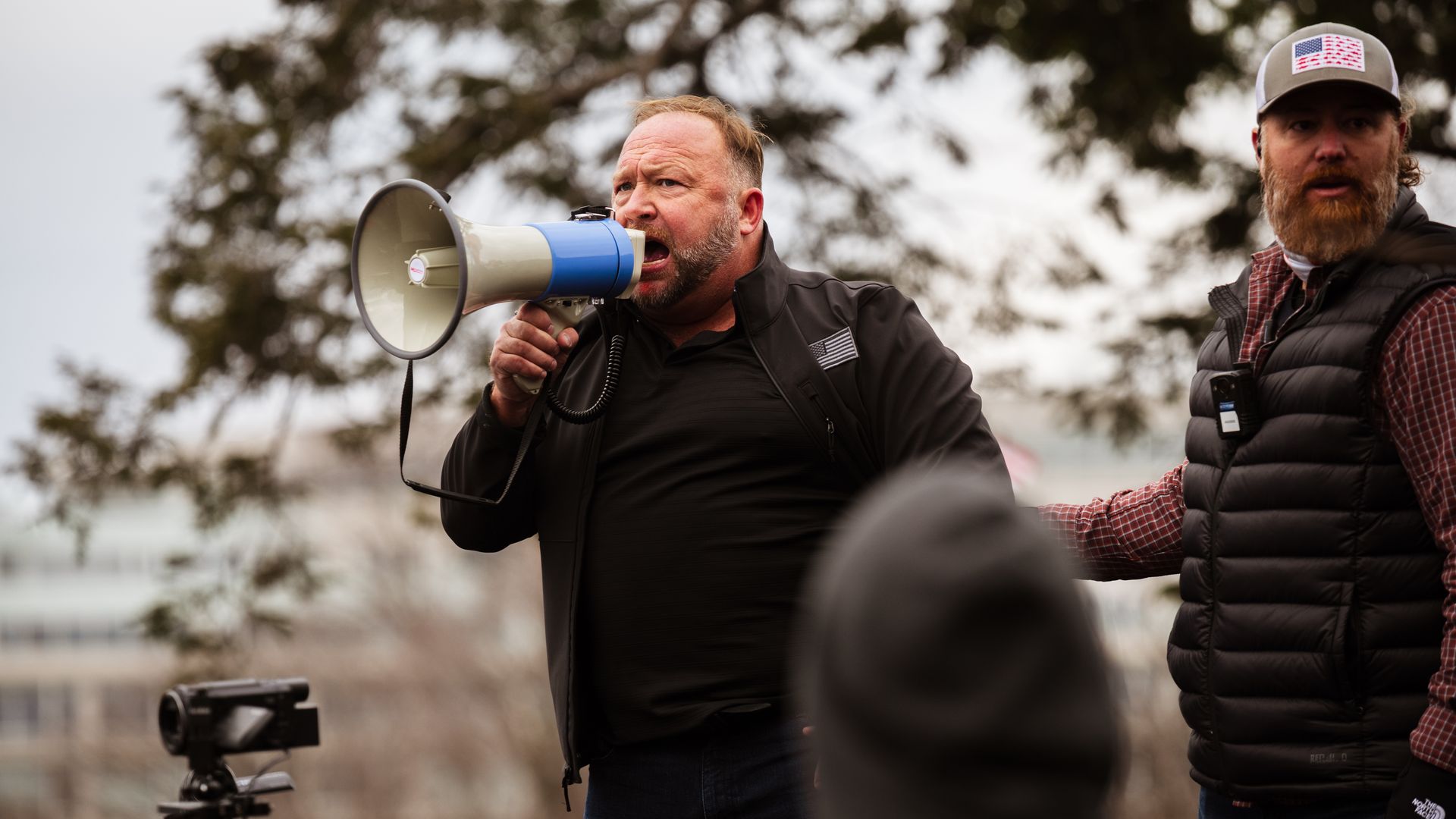 Conspiracy theorist Alex Jones speaks on a megaphone to pro-Trump protestors after they stormed the grounds of the Capitol on January 6, 2021.