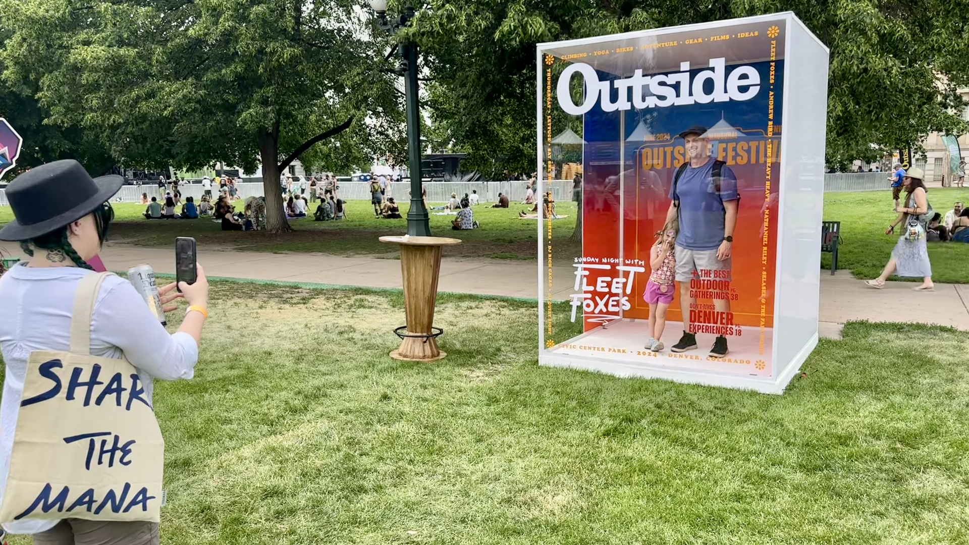 Outside Festival attendees take selfies in front of a sign