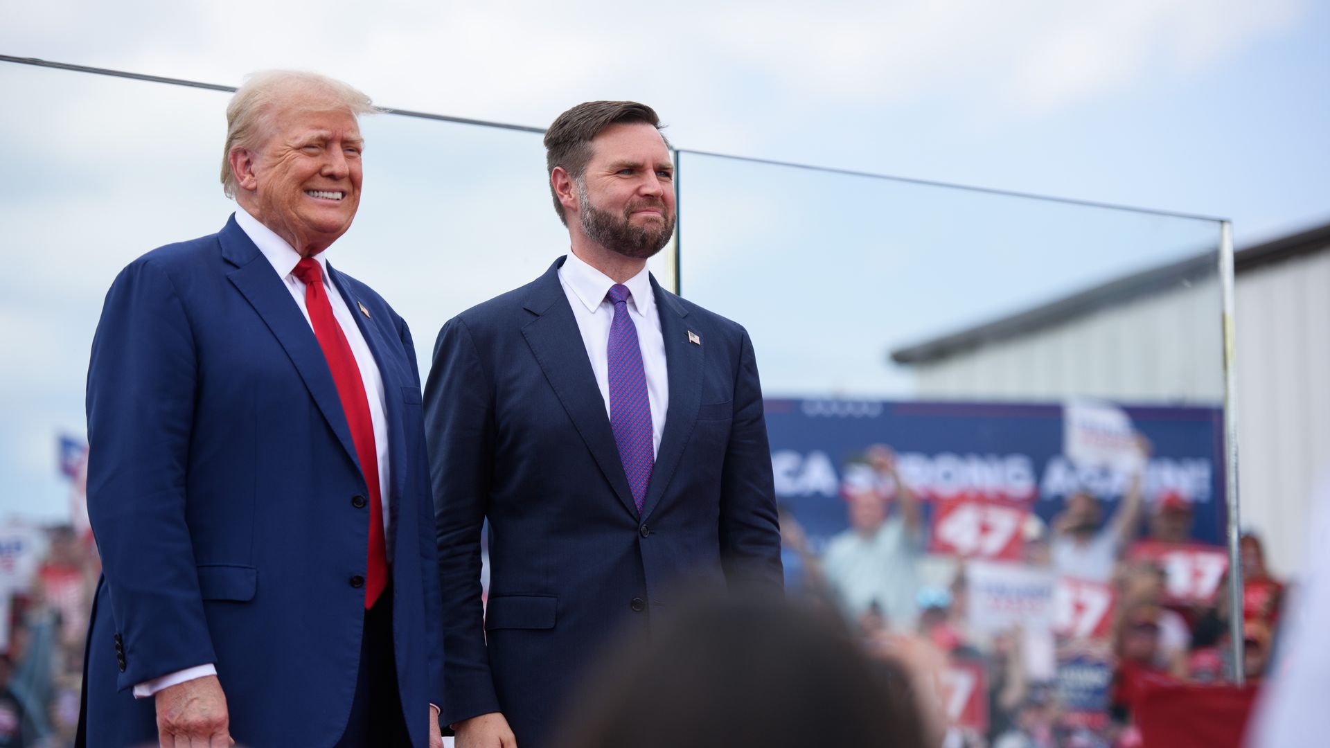 former U.S. president, Donald Trump, left, poses for photos with Republican Vice Presidential candidate, U.S. Sen. J.D. Vance, (R-OH), before making remarks to a crowd during an event on August 21, 2024 in Asheboro, North Carolina at the North Carolina Aviation Museum and Hall of Fame. Mr. Trump and