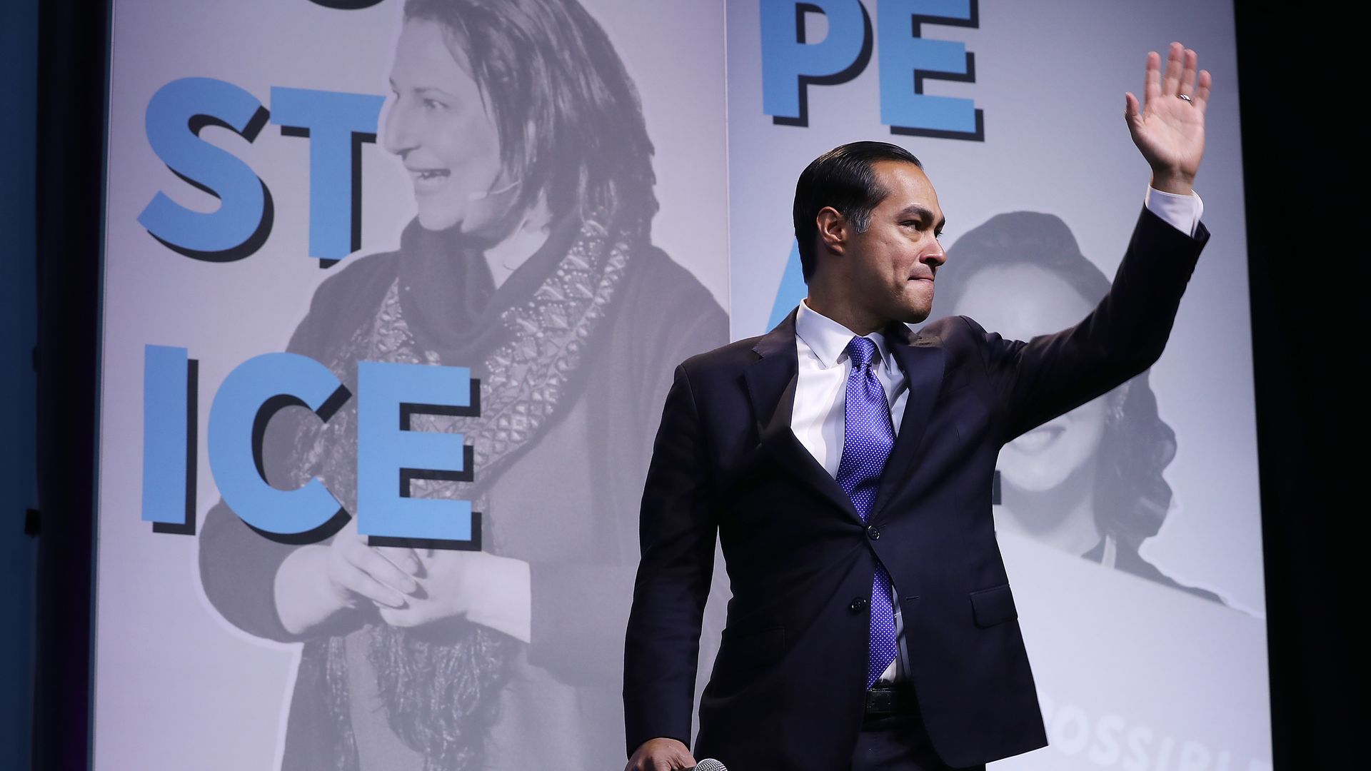 Julian castro waves at a crowd.
