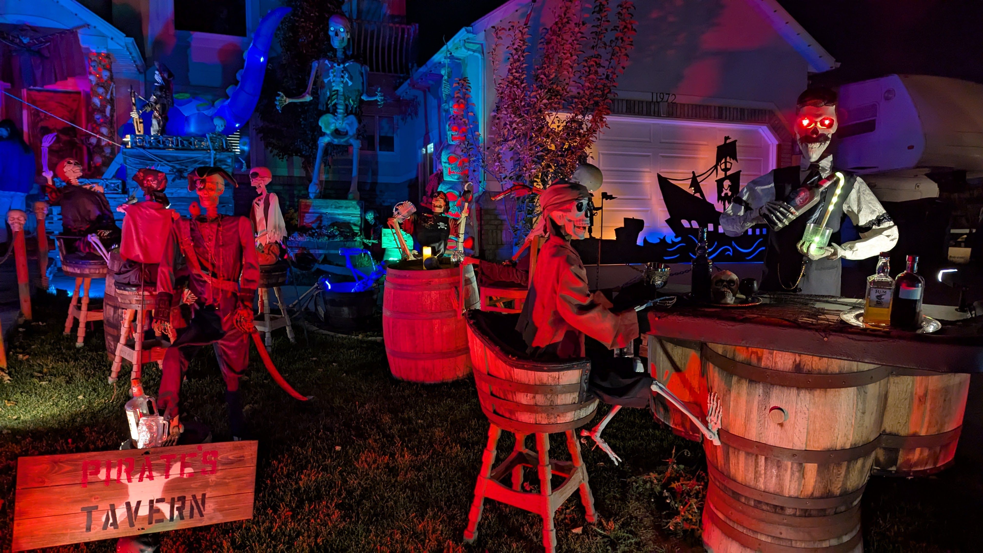 Skeleton pirates at a tavern, depicted in yard decorations.