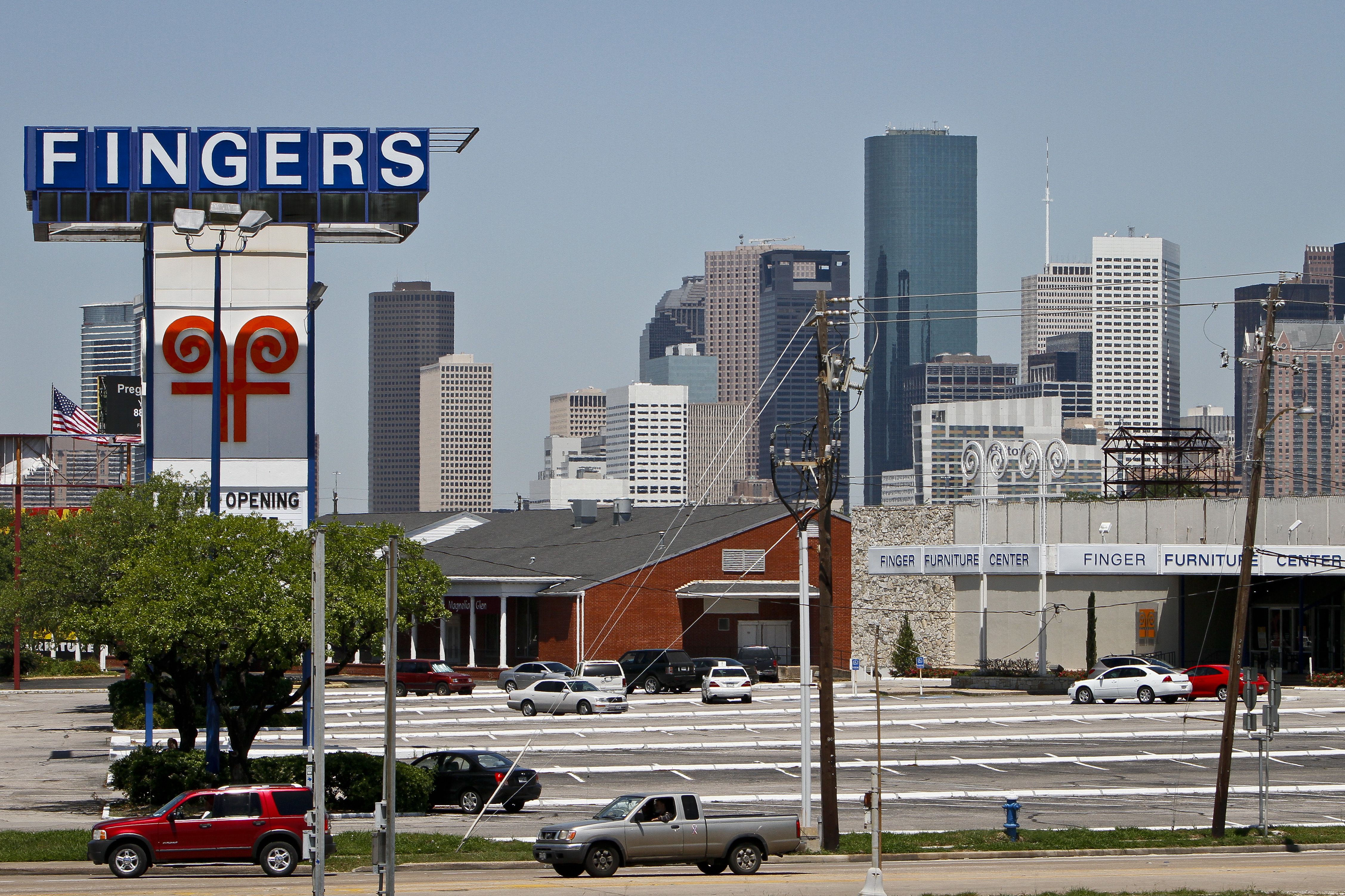 Finger Furniture sign with the Houston skyline in the background