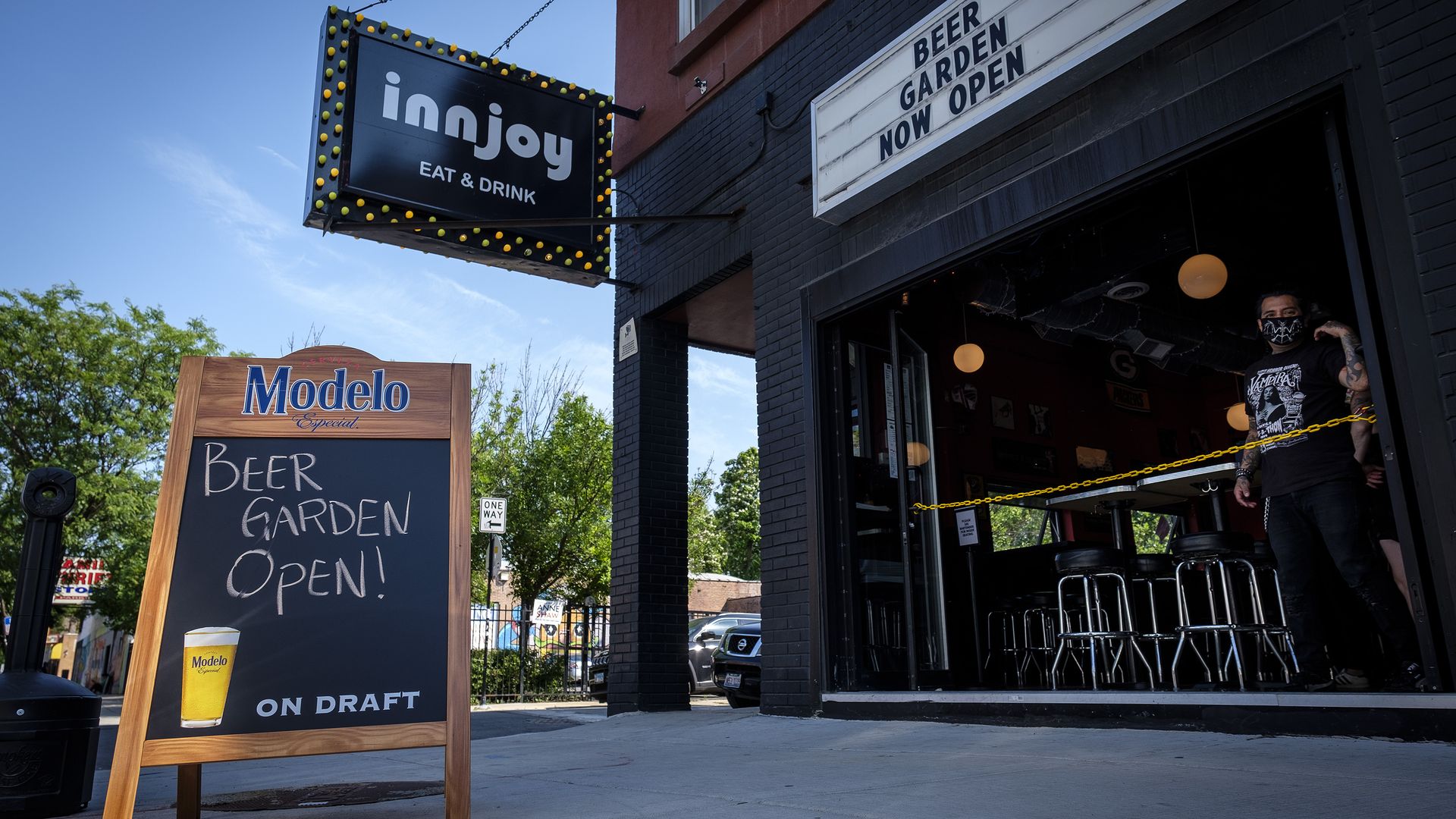 Signs indicate the beer garden is open at the Innjoy bar in Chicago, Illinois.