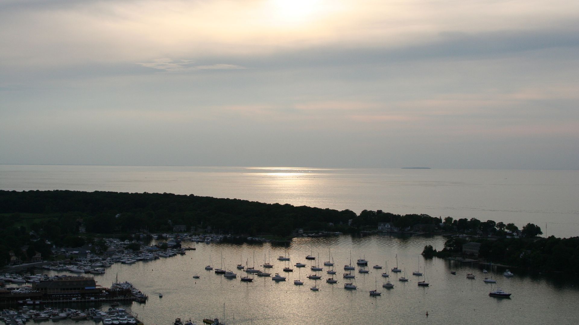An aerial view of boats in a bay on an island.