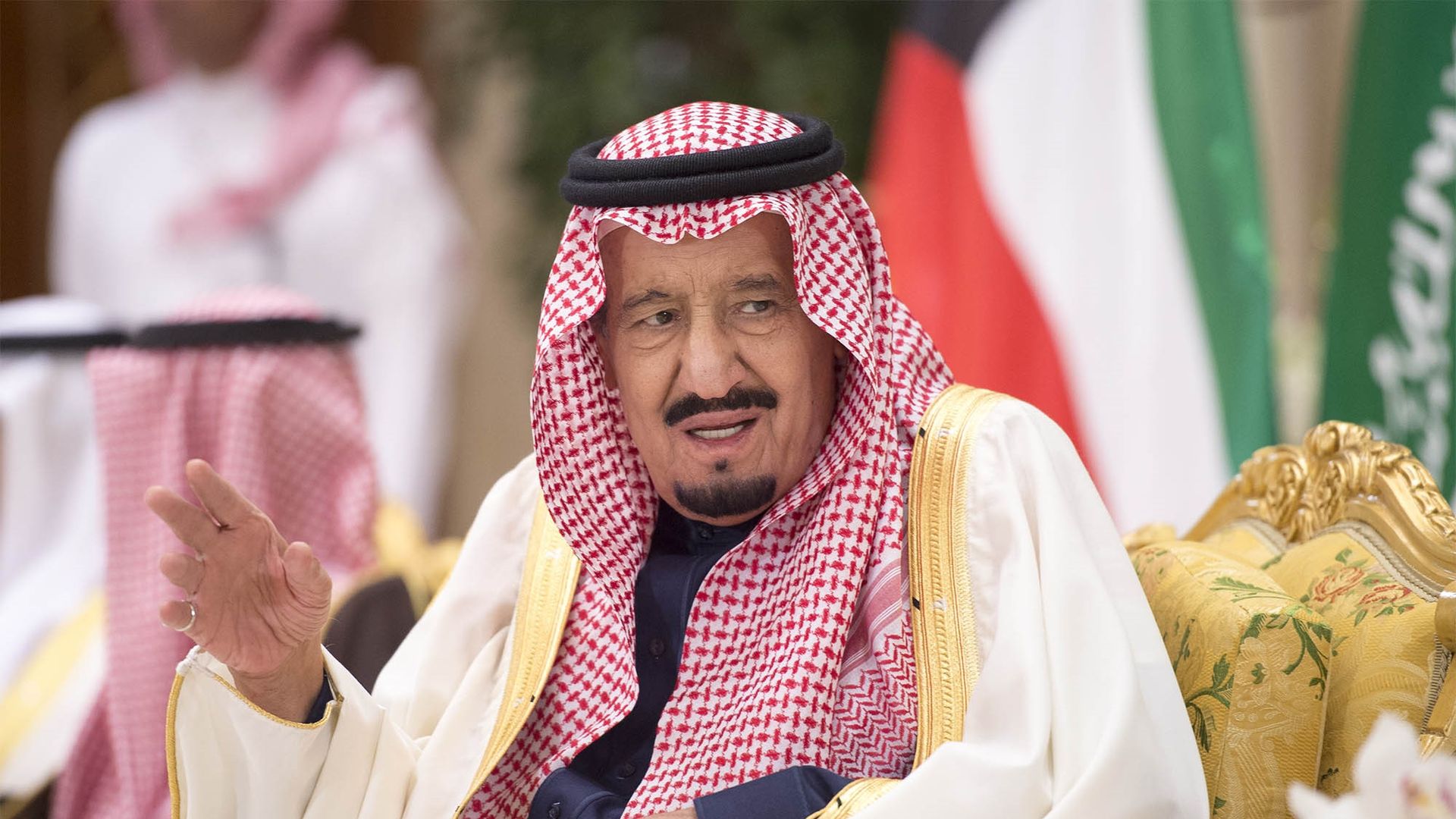 Saudi King Salman speaks with fingers up
