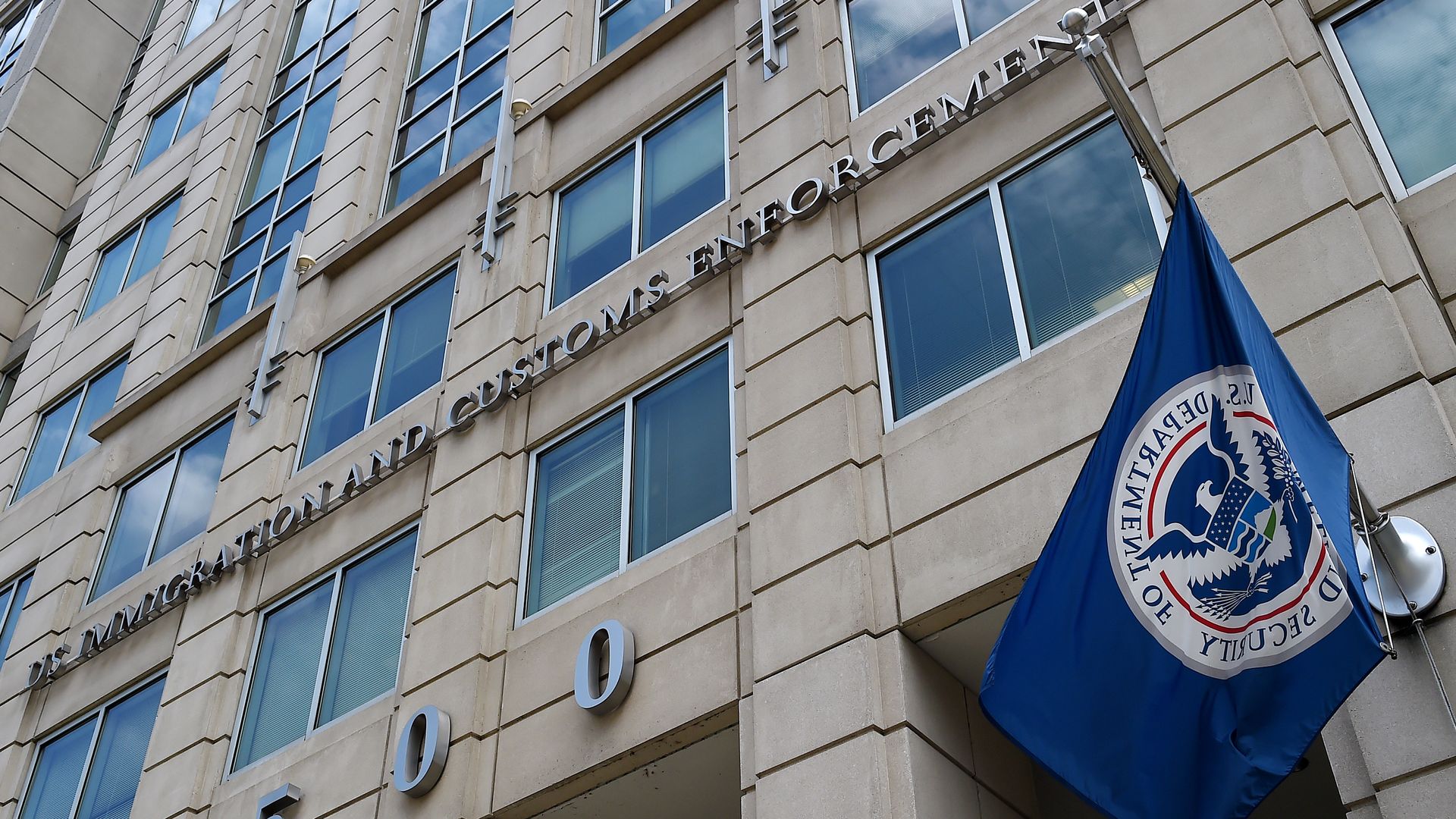 The Immigration and Customs Enforcement building in D.C. with a DHS flag flying out front