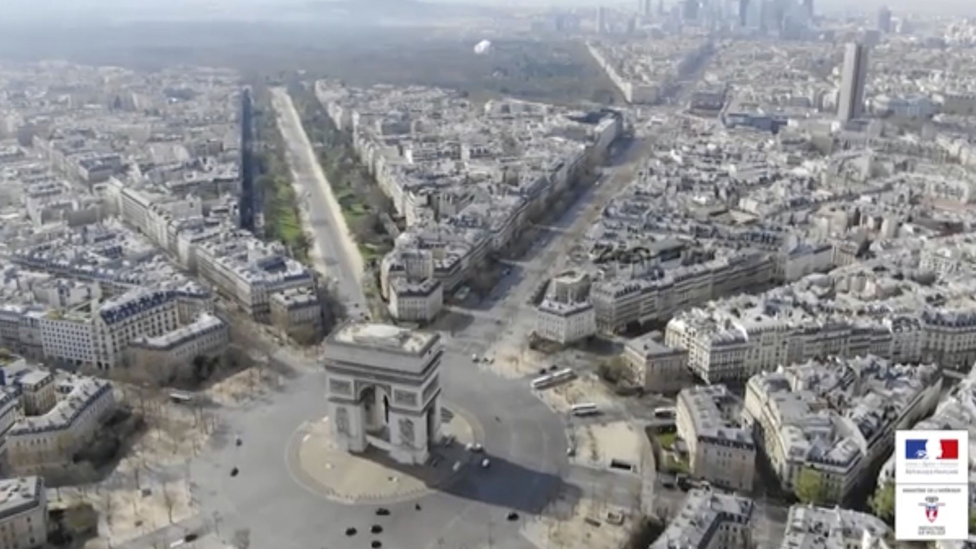 A photo shows the empty streets of Paris around the Arc de Triomphe