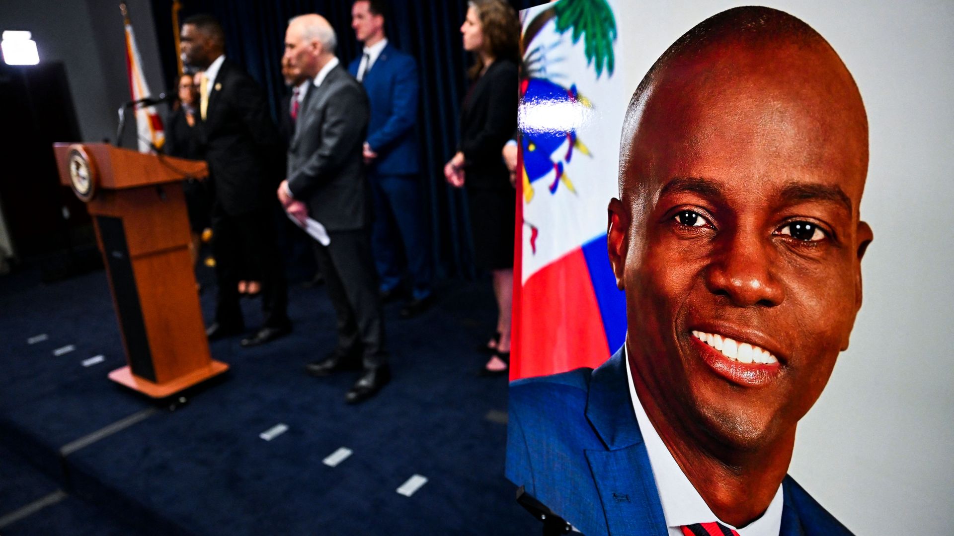Photo of a picture of Jovenel Moise propped up at a press conference held by federal authorities