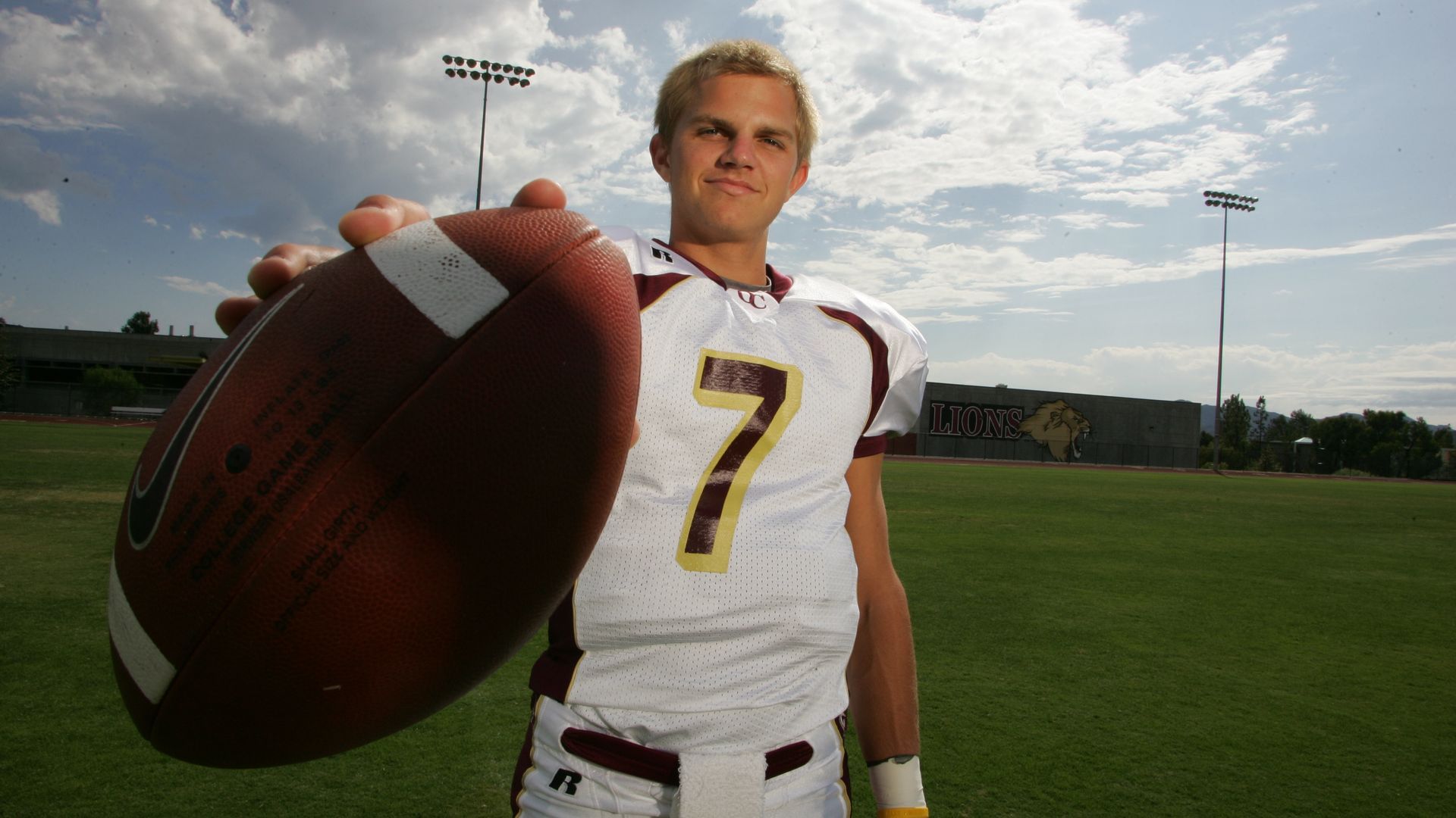Jimmy Clausen posing with the football in high school
