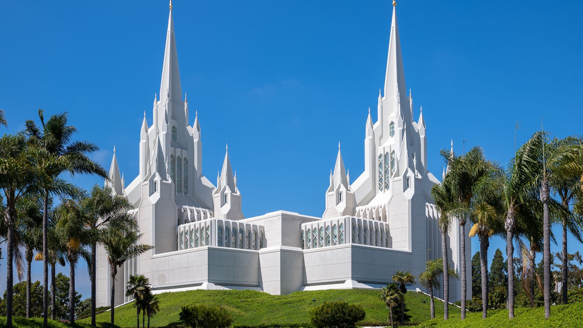 Photo of the San Diego California Temple against a blue sky and green grass