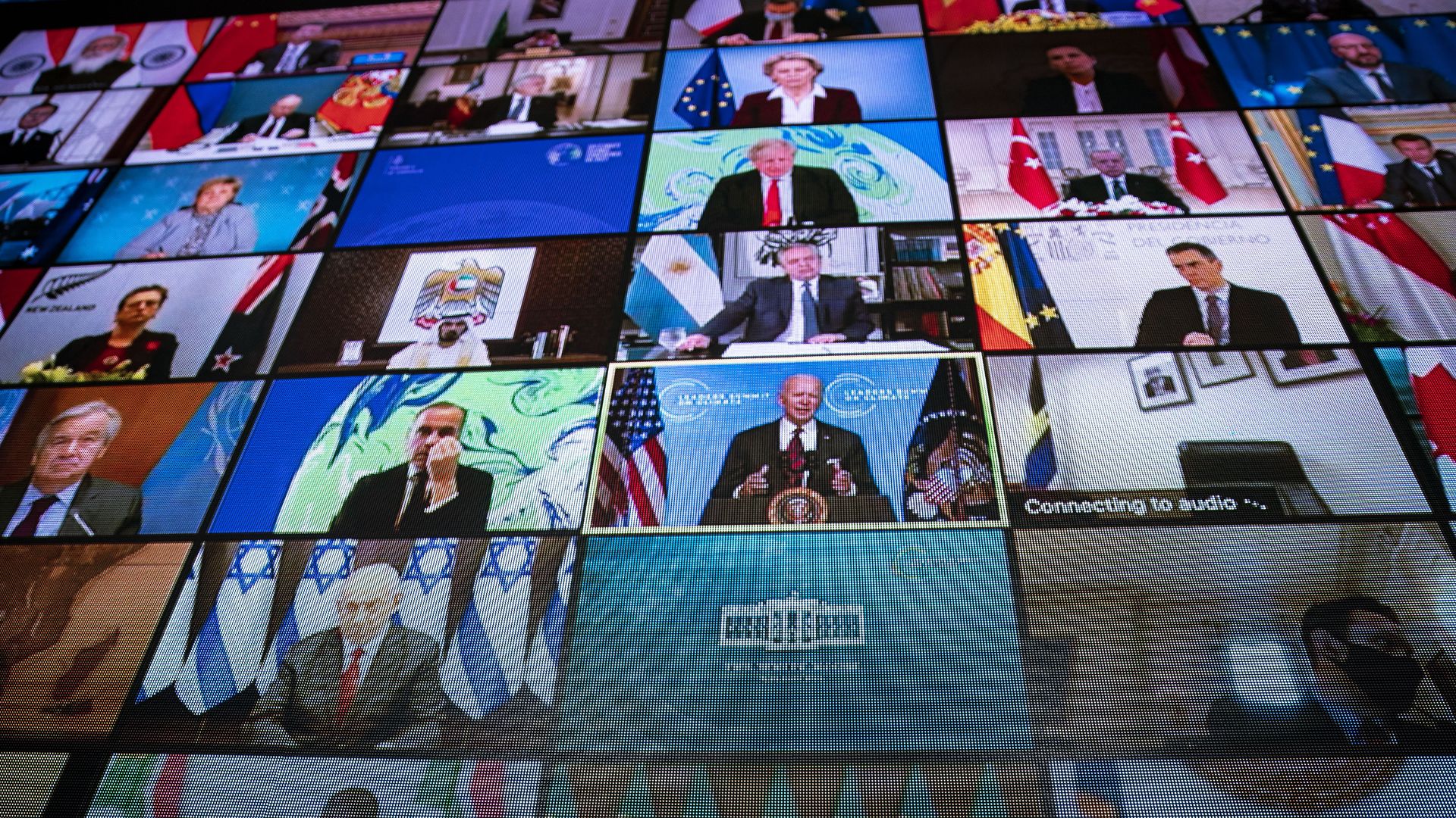 World leaders are seen remotely on a screen as U.S. President Joe Biden delivers remarks during a virtual Leaders Summit on Climate with 40 world leaders in the East Room of the White House