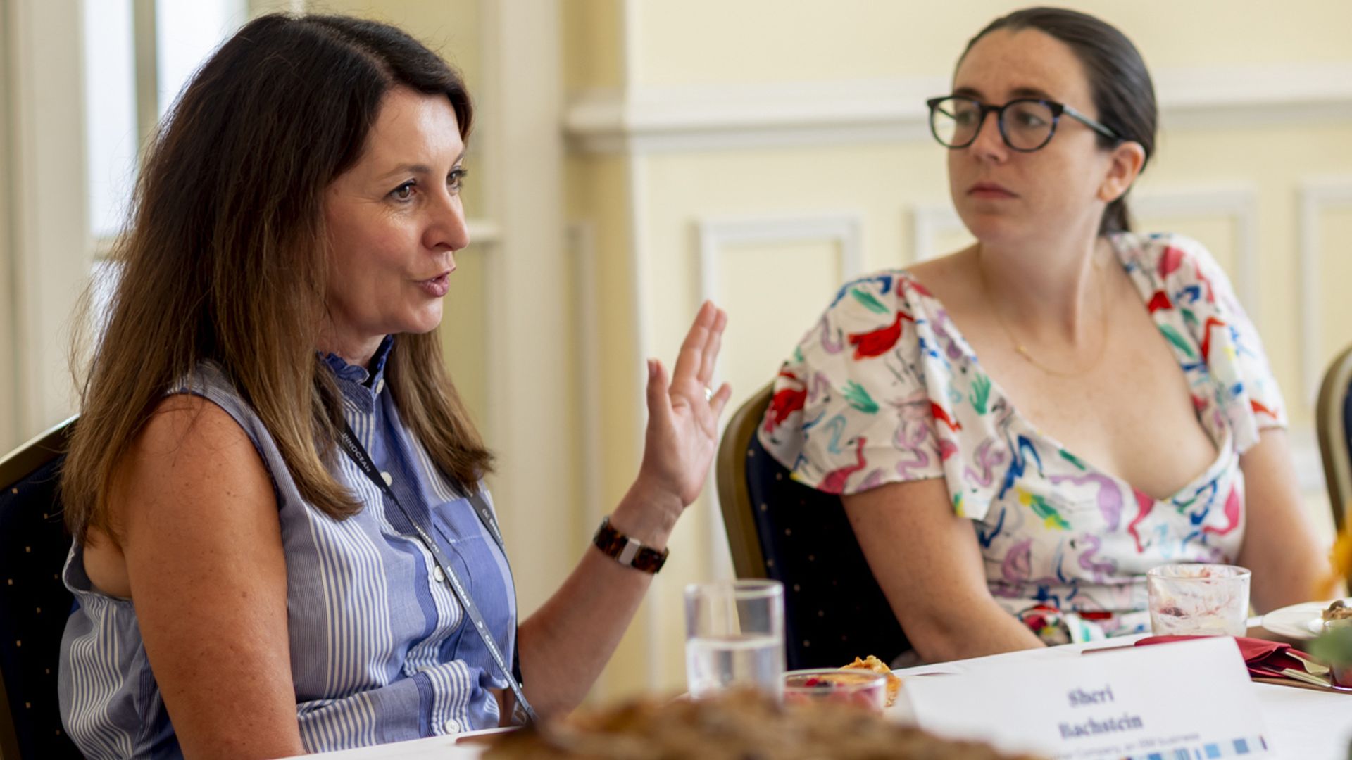 The Weather Company CEO Sheri Bachstein and Axios' Kerry Flynn sitting at a table