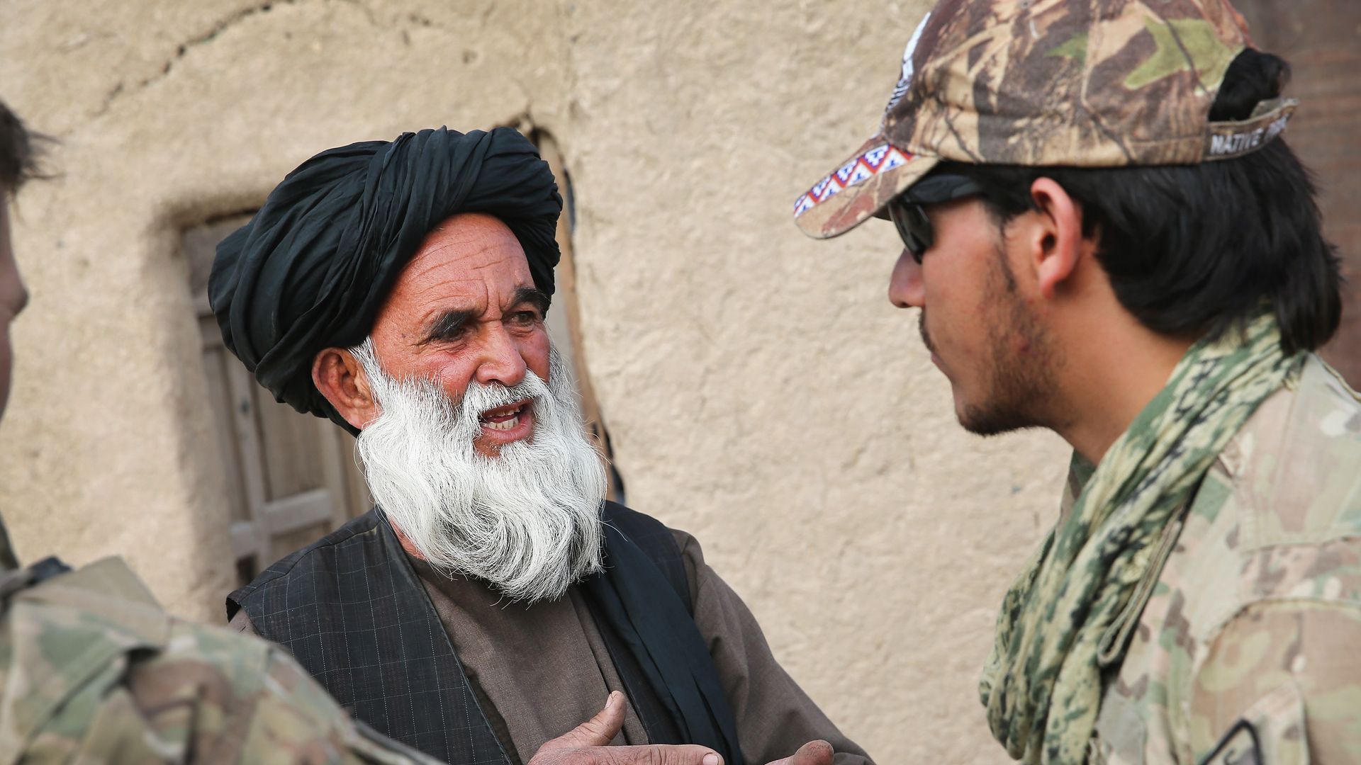 An Afghan interpreter with the U.S. Army's 4th squadron 2d Cavalry Regiment helps to question a village