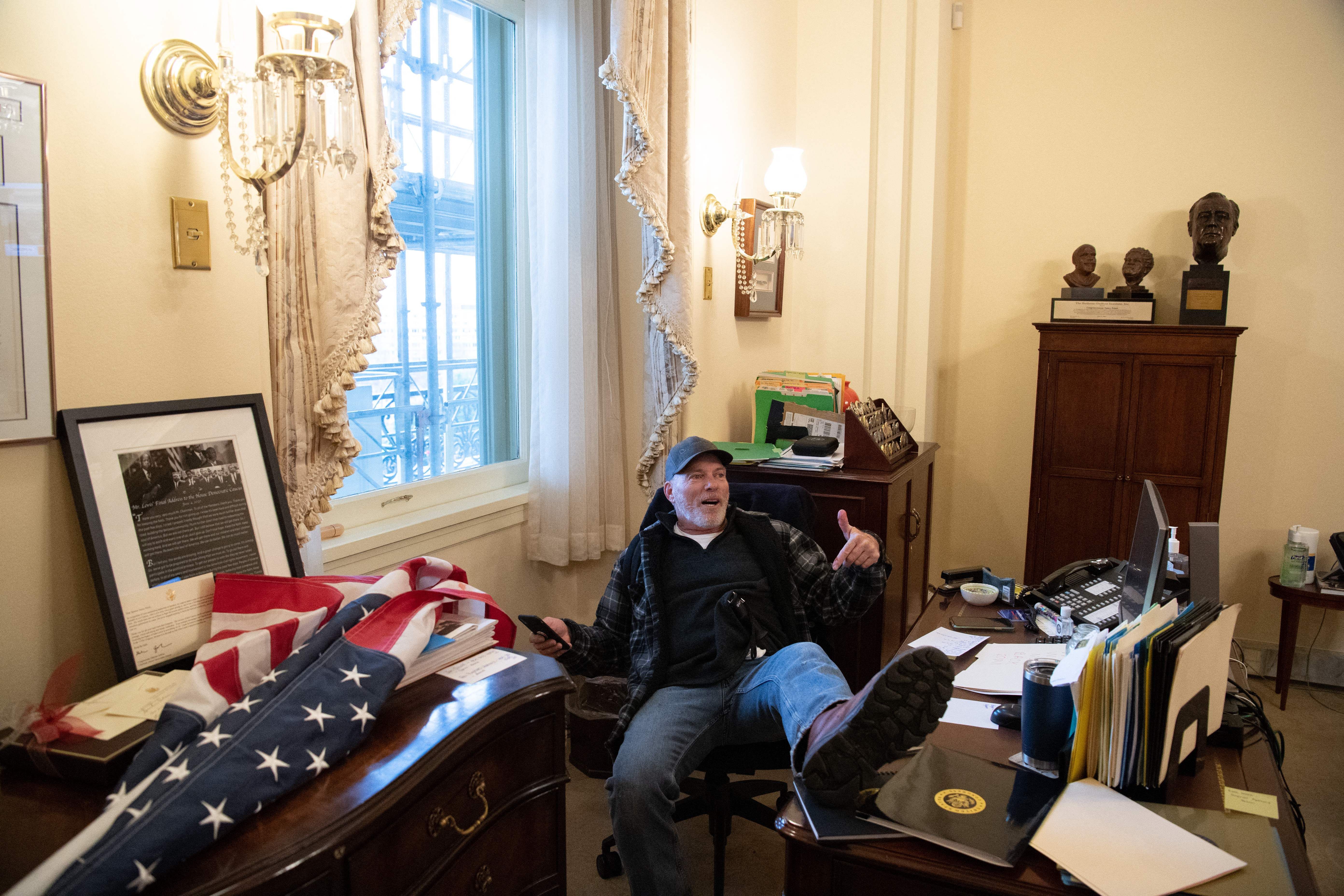 Picture of a man sitting on Nancy Pelosi's desk chair