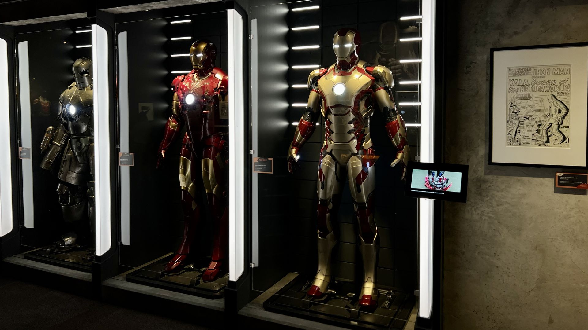 three mannequins dressed in super hero costumes