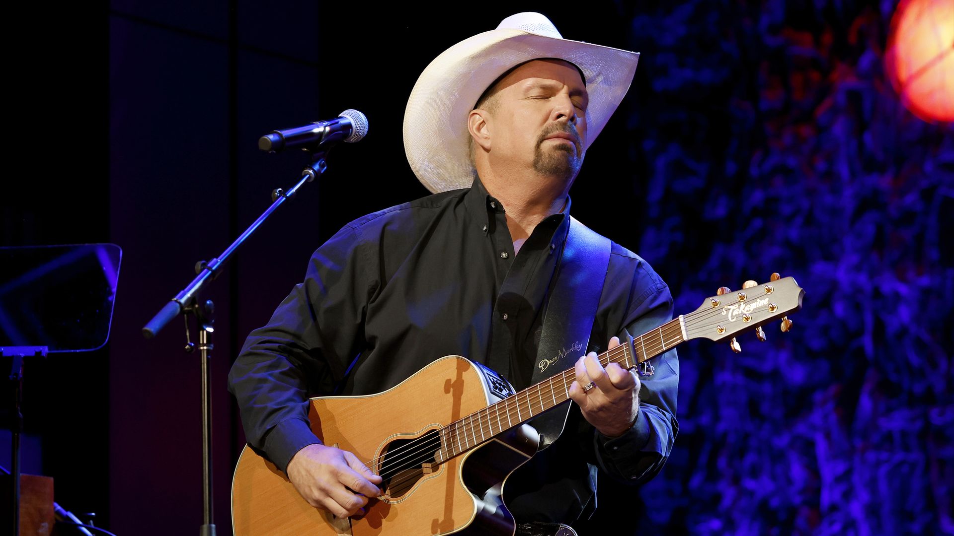 Photo shows Garth Brooks performing on stage