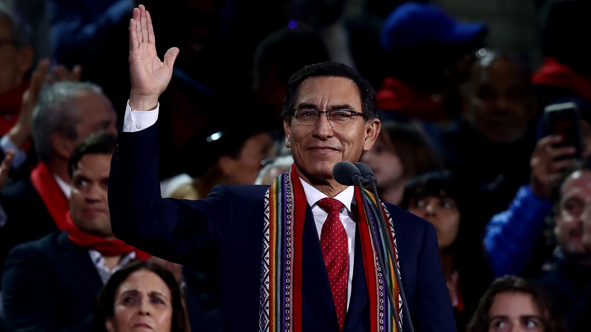 Martin Vizcarra waving in front of a stadium crowd