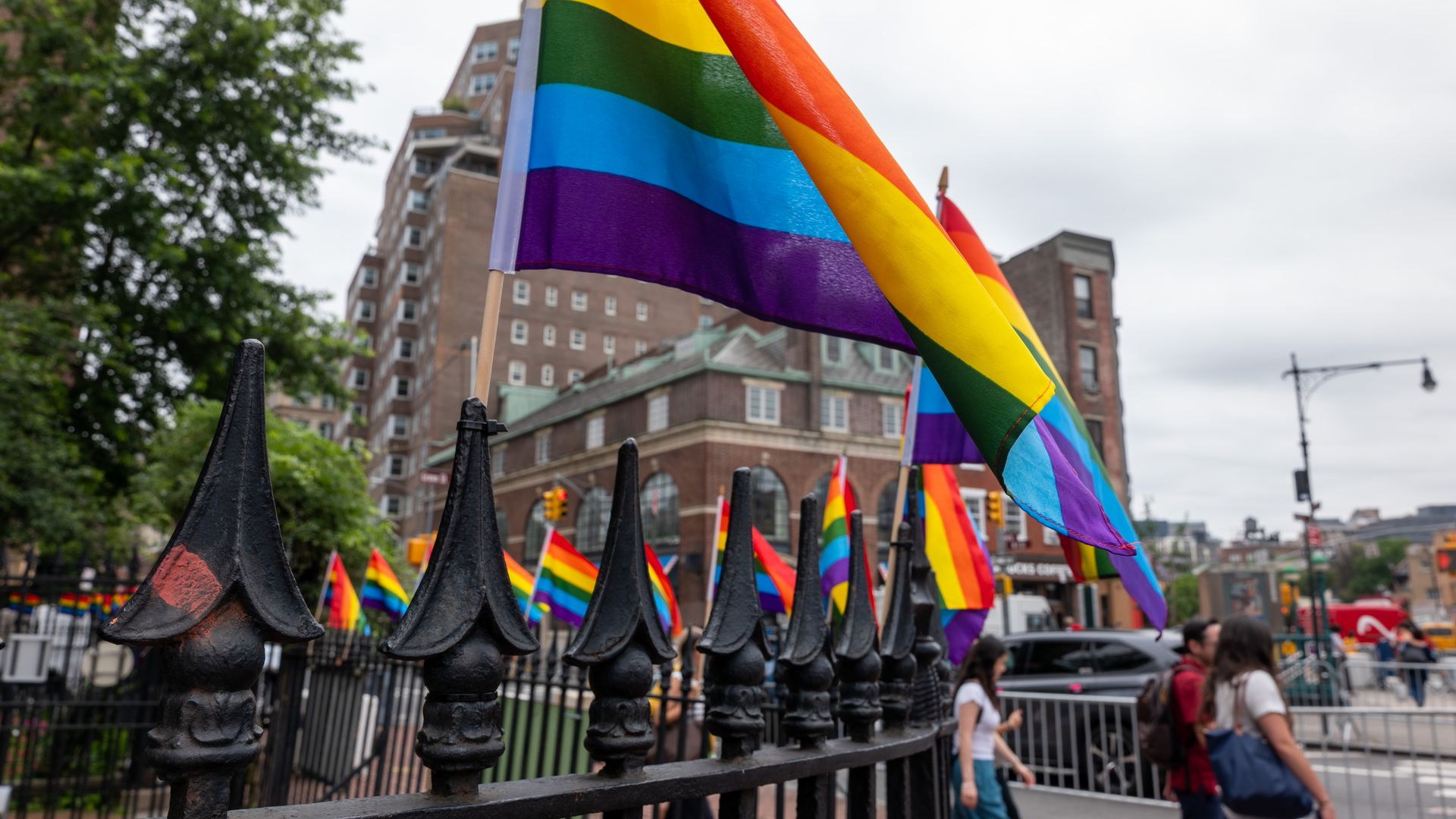 Pride flags surround the fence of the Stonewall National Monument 