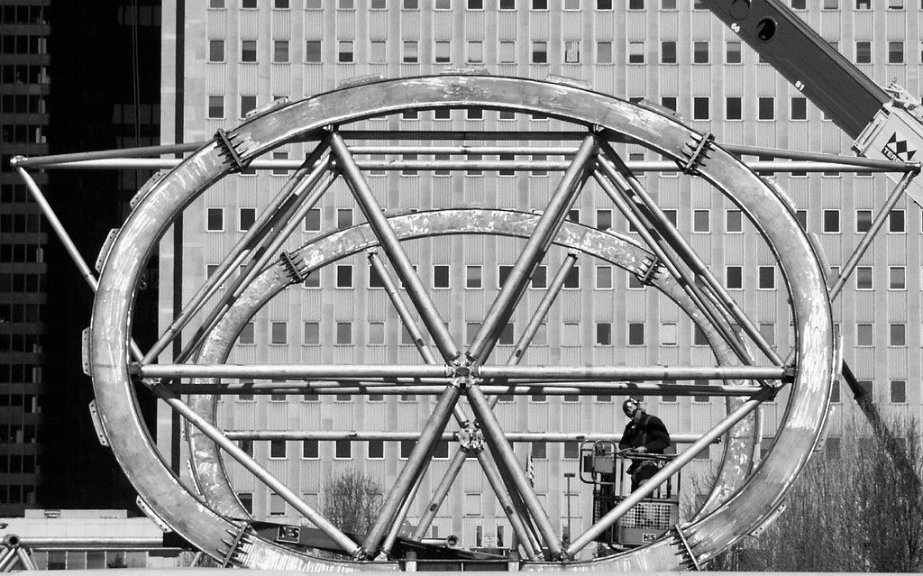 Black and white image of oval structure with poles running from side to side.