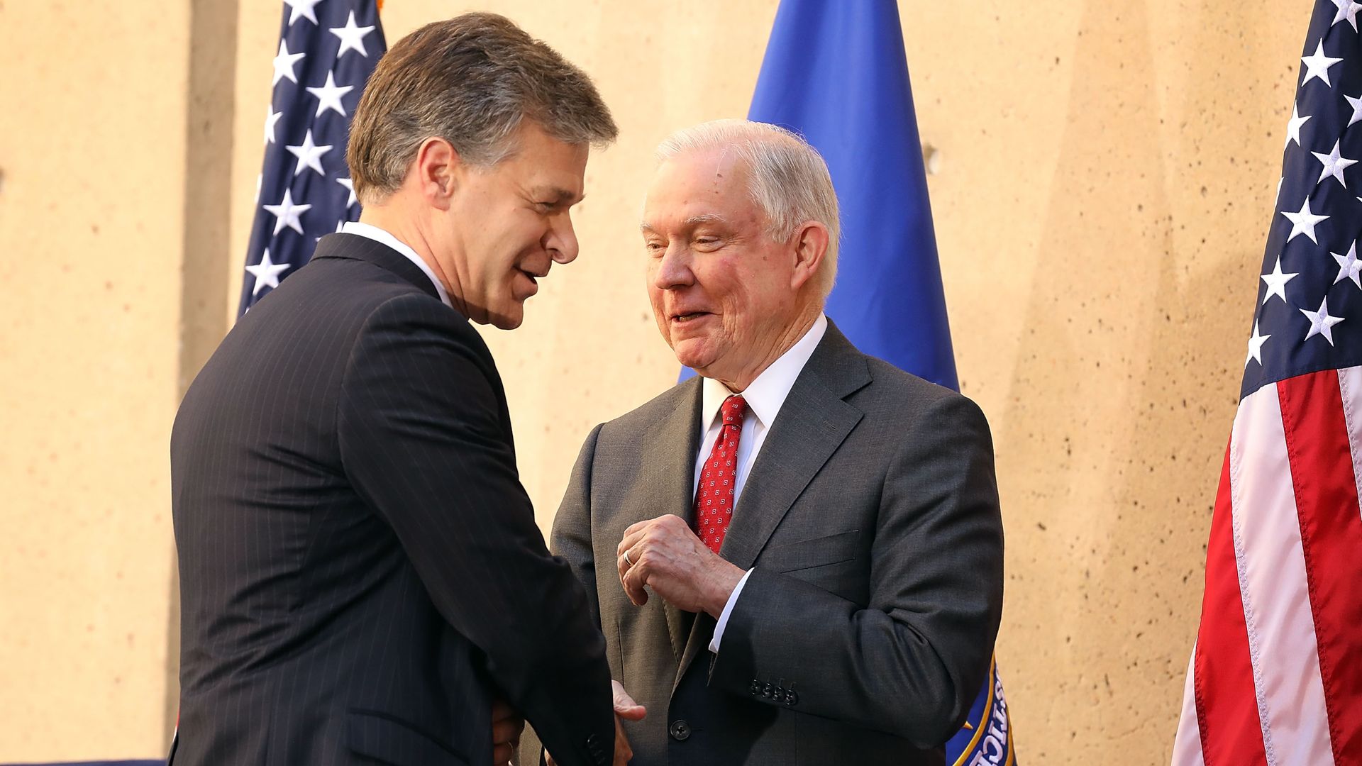 Chris Wray and Jeff Sessions shake hands