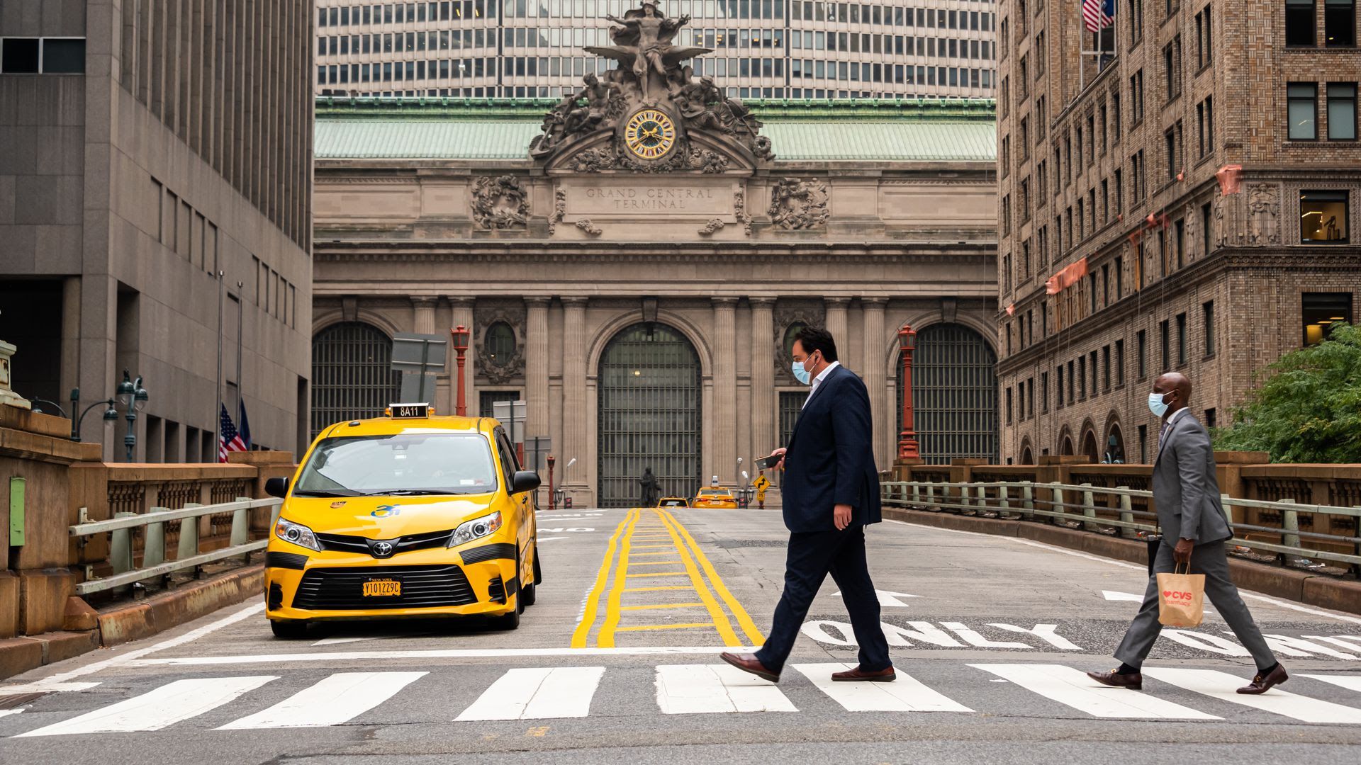 People wear face masks outside Grand Central Terminal in New York City.