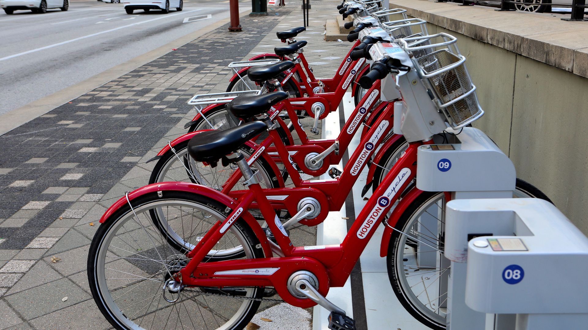 Several bright red bicycles sit at a BCycle station in downtown Houston 