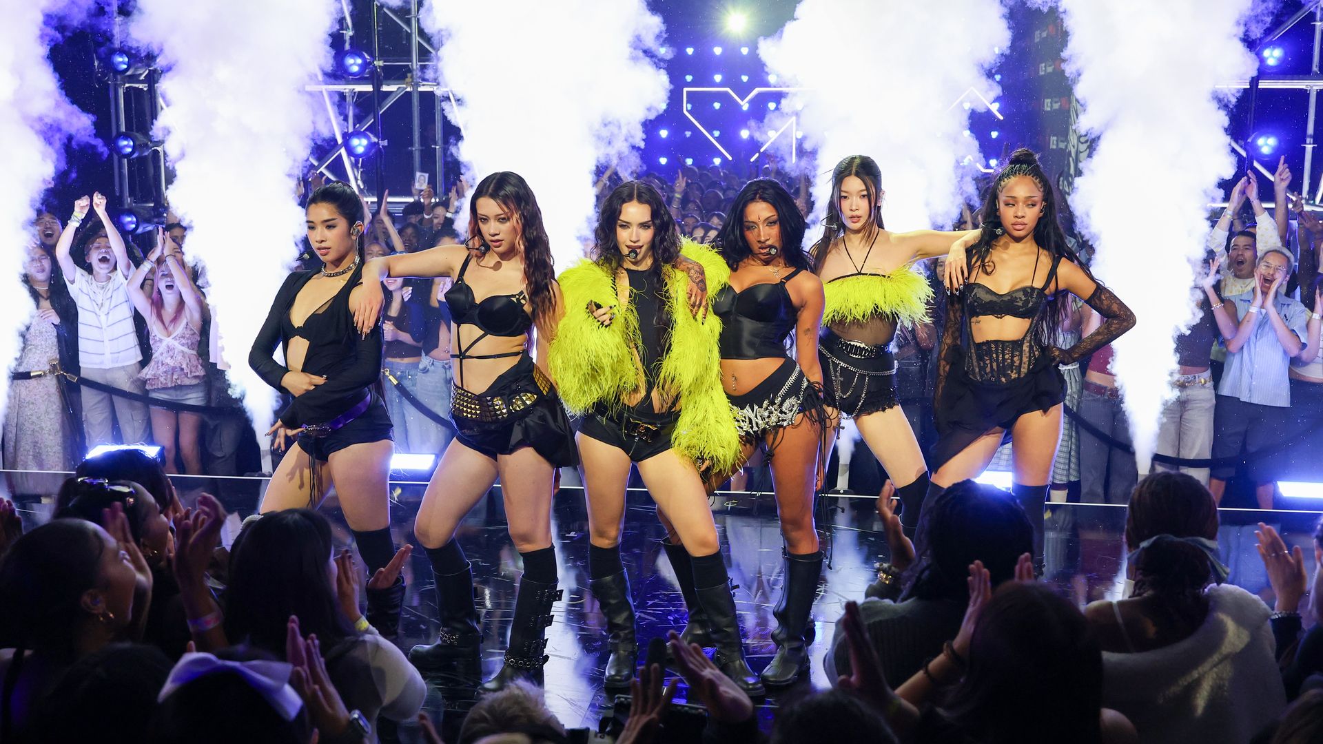 Katseye on stage with fog behind them