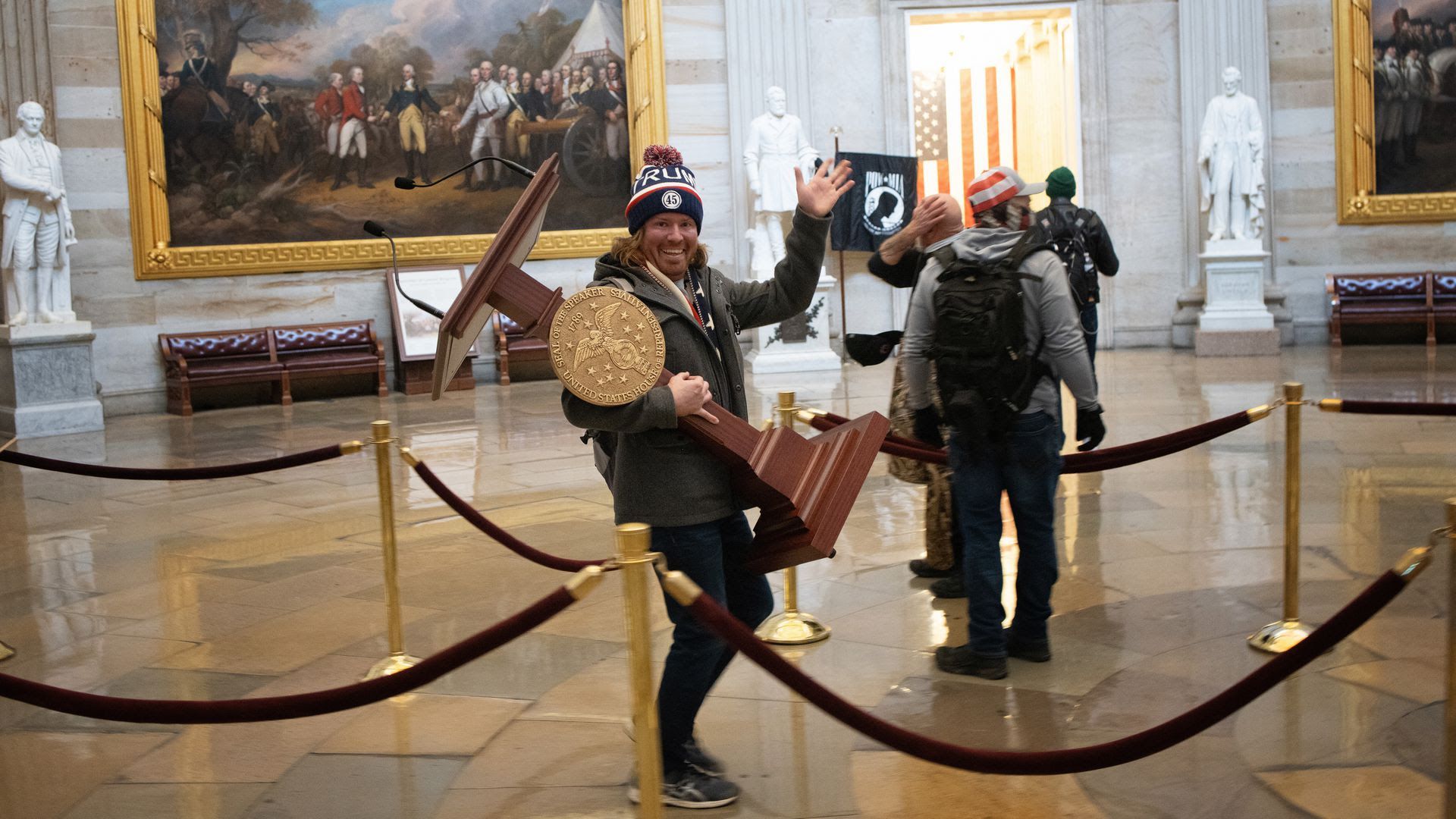 Adam Johnson carries the lectern of U.S. Speaker of the House Nancy Pelosi through the Rotunda of the U.S. Capitol Building after a pro-Trump mob stormed the building on January 06, 2021.