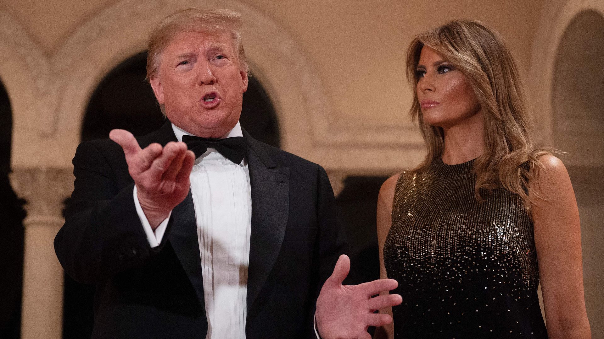 President Donald Trump and First Lady Melania Trump speak to the press outside the grand ballroom as they arrive for a New Year's celebration at Mar-a-Lago in Palm Beach, Florida, on December 31