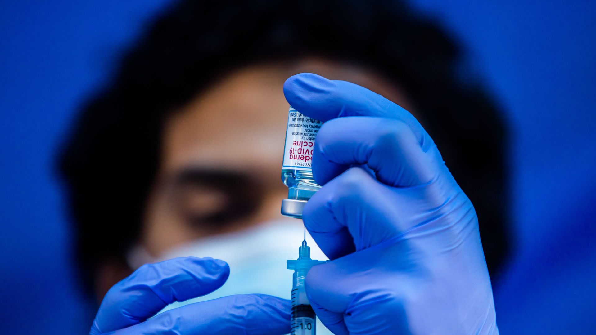 A nurse holds a Moderna vaccine.