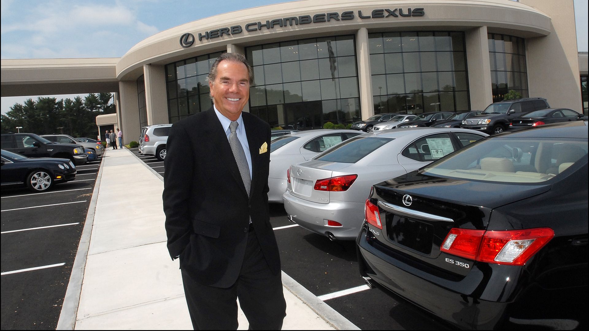 A man and a car dealership